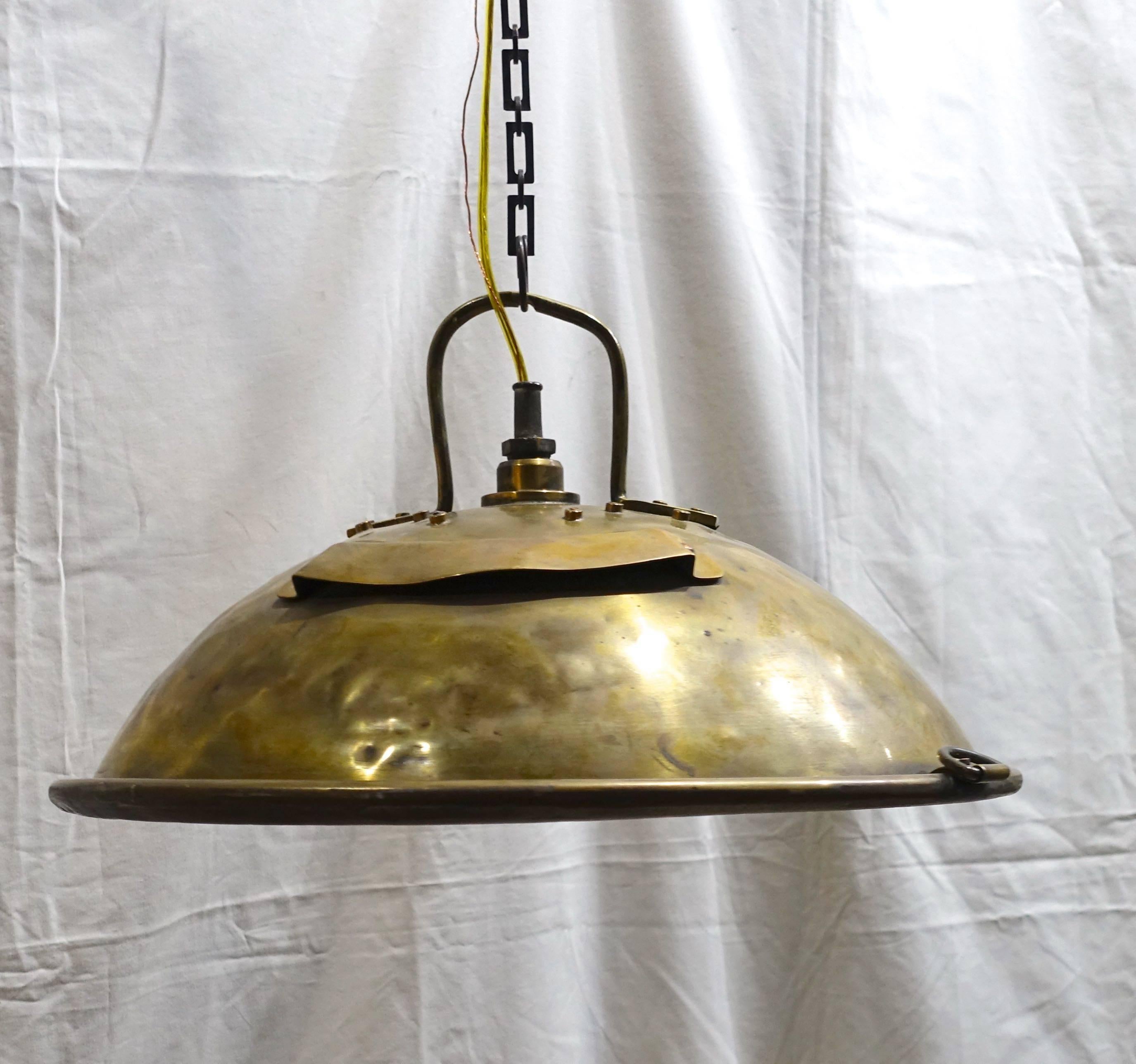 1920s English brass Industrial light fixture originally used as a ship light.
The fixture has a decorative original chain and holds four light bulbs.
Recently rewired, the ceiling cap is supplied with the fixture.