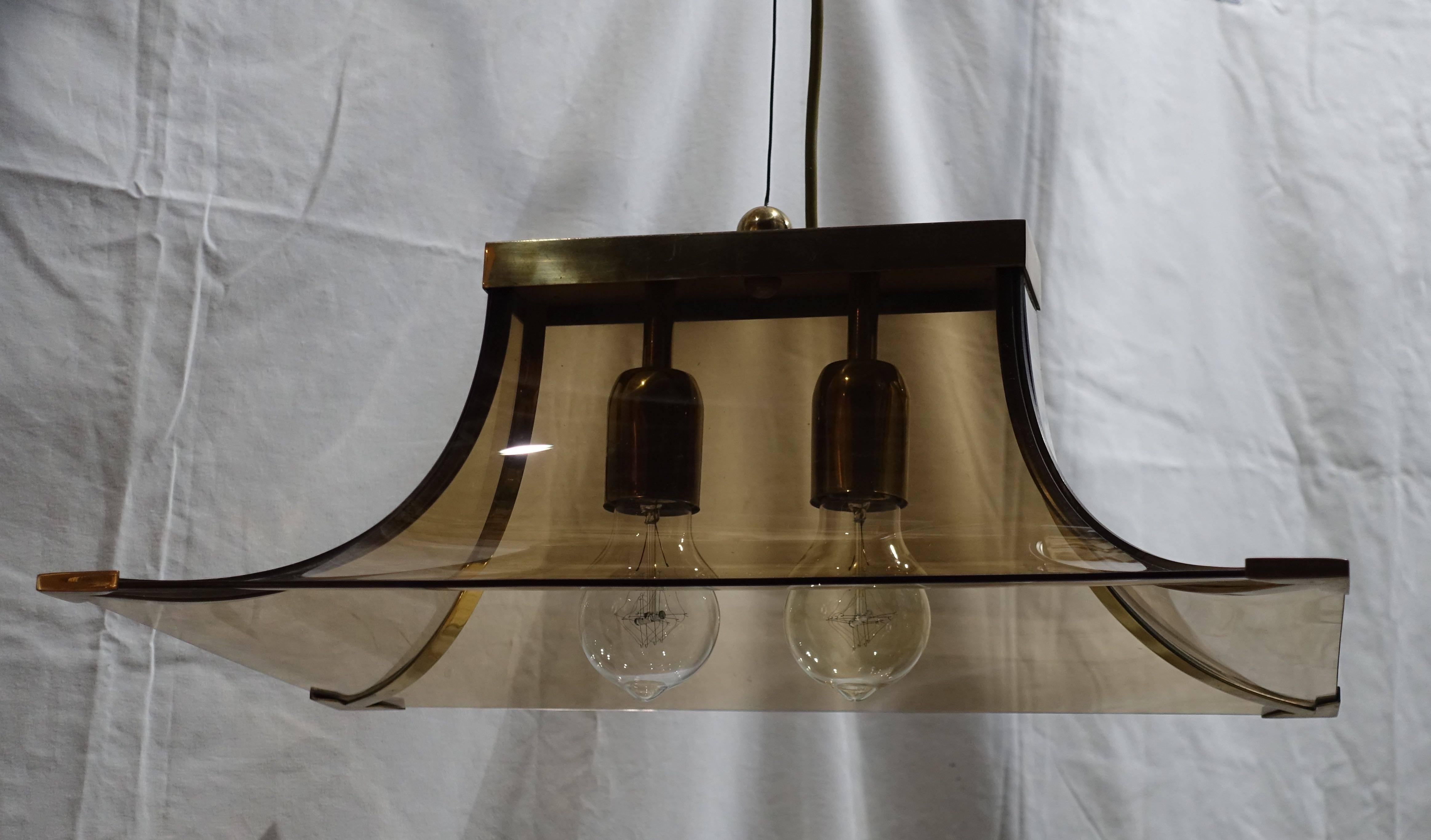 1970s Italian smoked taupe glass curved chandelier.
The chandelier has two brass sockets and brass strips trimming the edges and corners.
Recently rewired. Ceiling cap is included.
The chandelier is in excellent condition.
