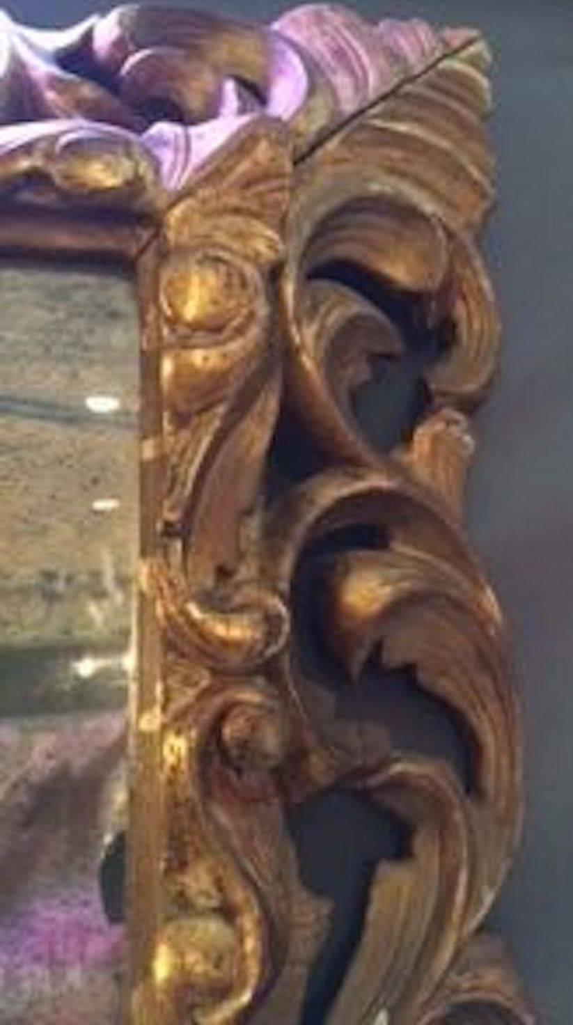 French ornately carved wood gold gilt framed mirror, circa 1830.
The mirror is original.
  