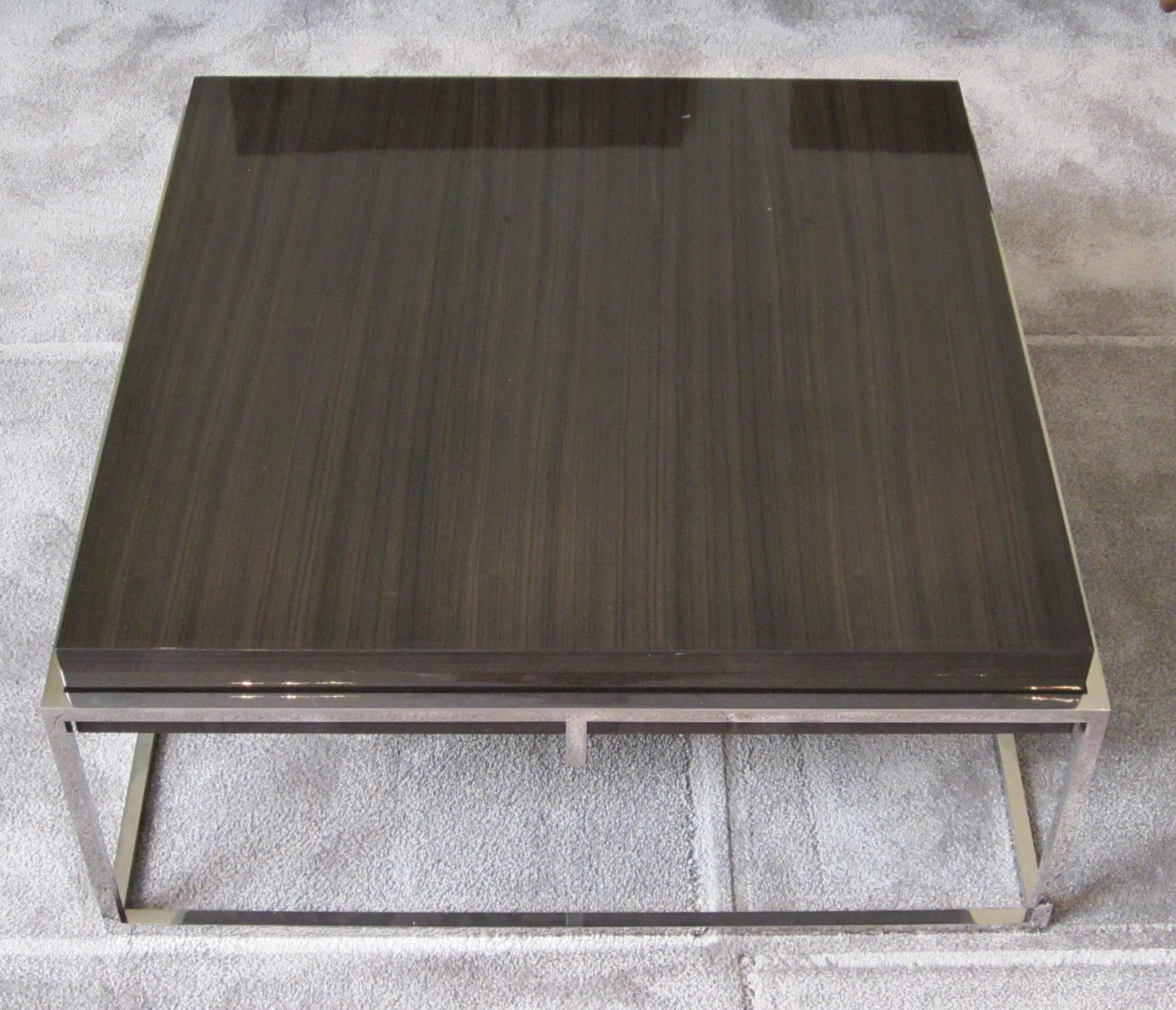 Contemporary Belgian square coffee table. Polished stainless cube base with laminated grey Awari wood top.
  