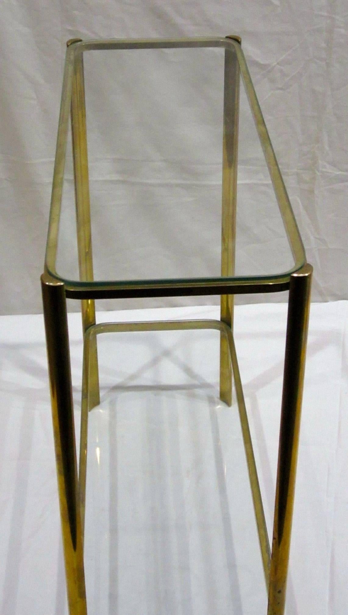 1940s French Maison Malabert bronze side table with two tiers of glass.
Attributed to Jacques Quinet, a very sought after furniture designer, known for his work in bronze.
His furniture designs are pared down, having very little ornamentation. The
