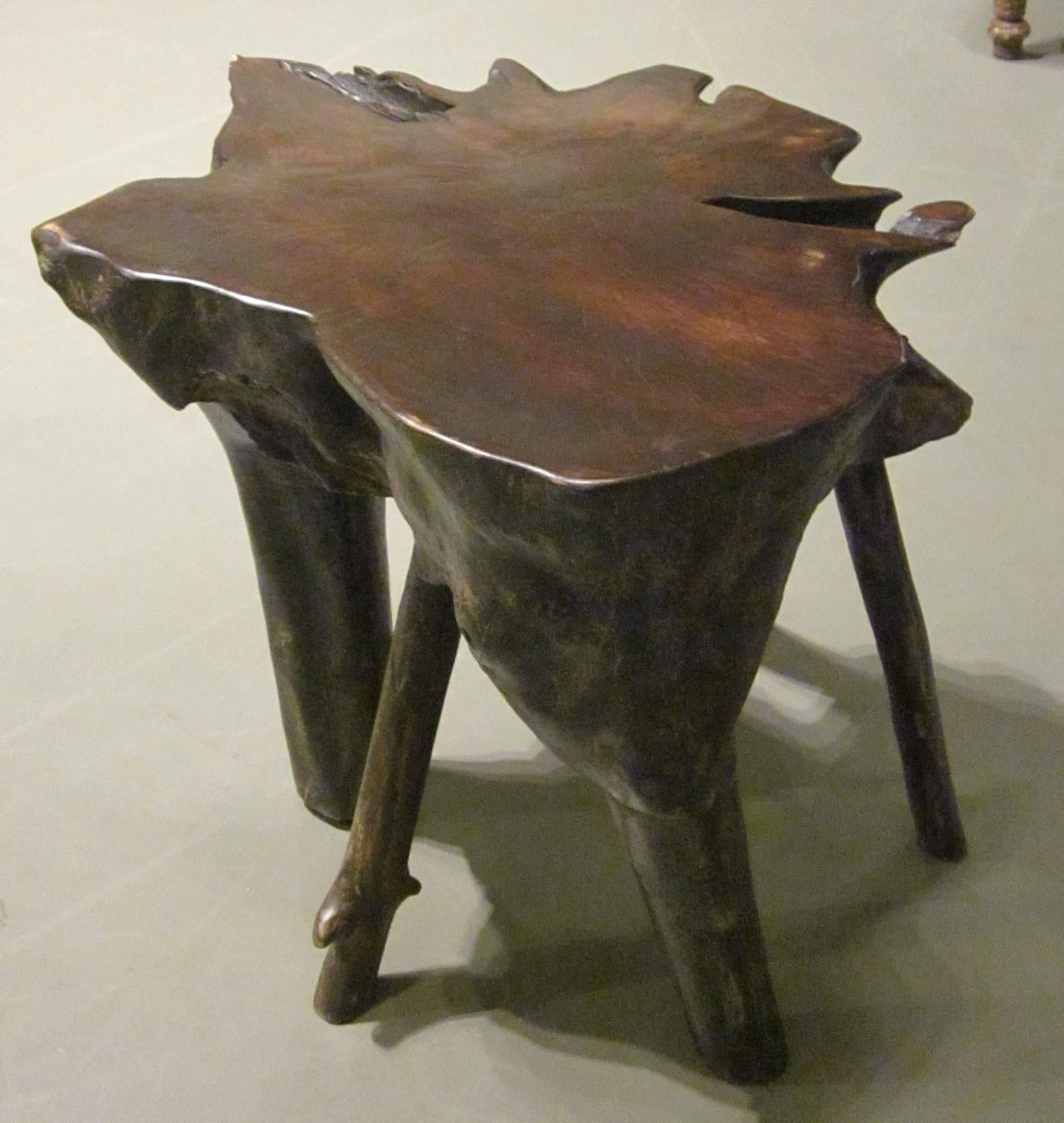 Contemporary Indonesian lychee wood multi leg cocktail table.
This organic, free-form shaped table has five legs.
The top is smooth, sides and legs are textured.
   