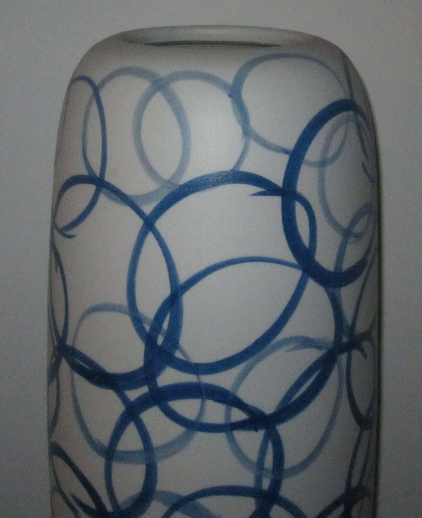 Contemporary Chinese large white porcelain vase with blue circle design.
This vase is 23.5