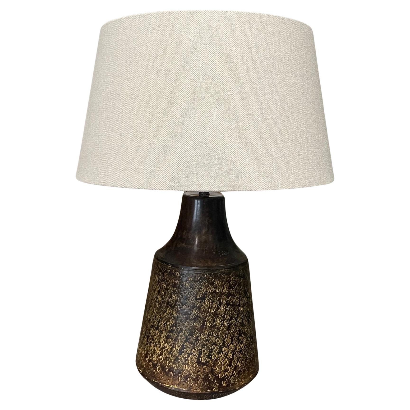 Contemporary Chinese pair textured metal lamps.
Top of base has mottled decorative pattern design.
Bottom of base is solid.
Belgian linen shades included.
Shade diameter 16