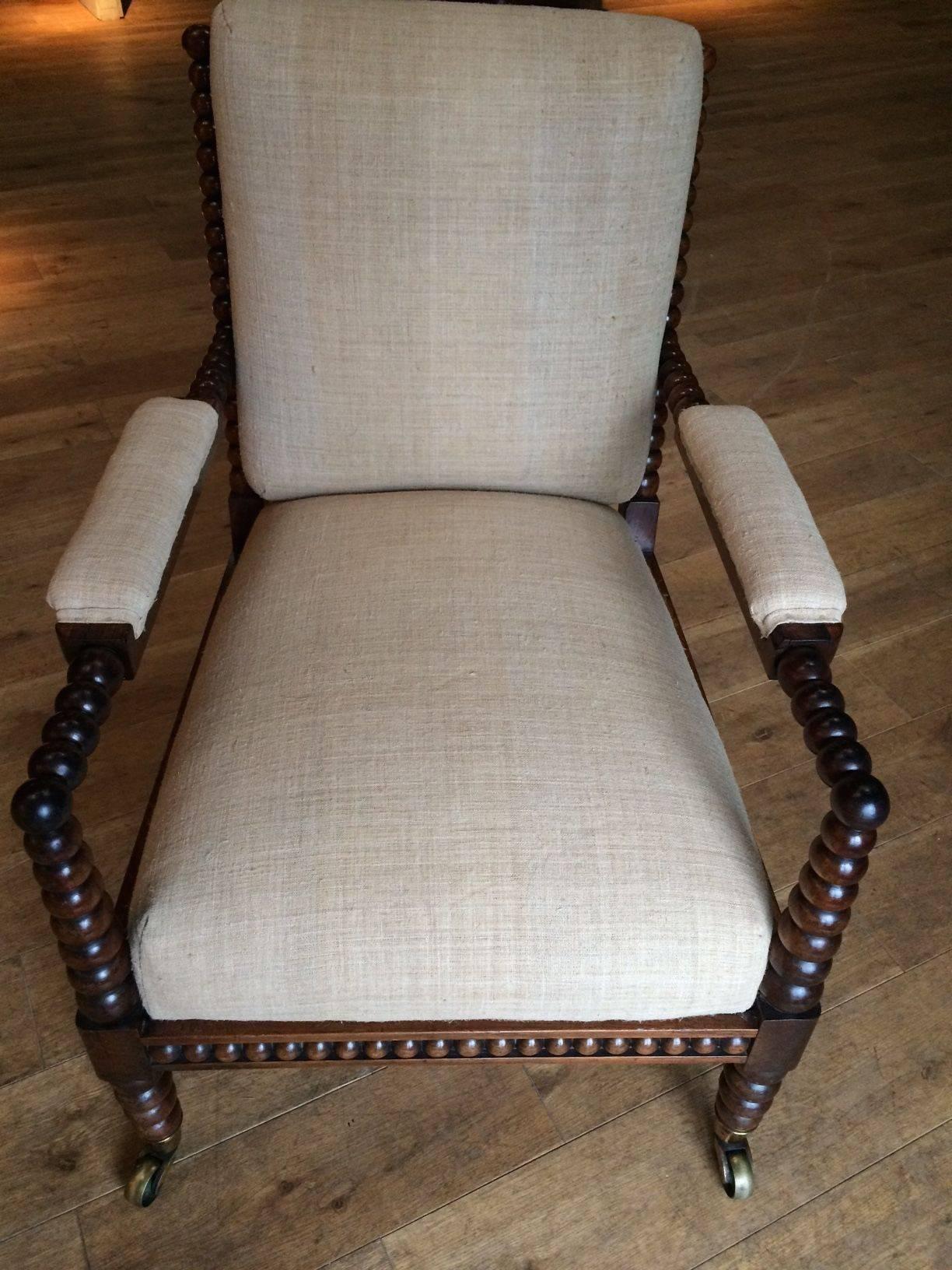 19th century English single upholstered bobbin side/armchair.
The chair has brass casters on wheels and has been recently reupholstered in vintage linen.
It is in excellent condition.

 