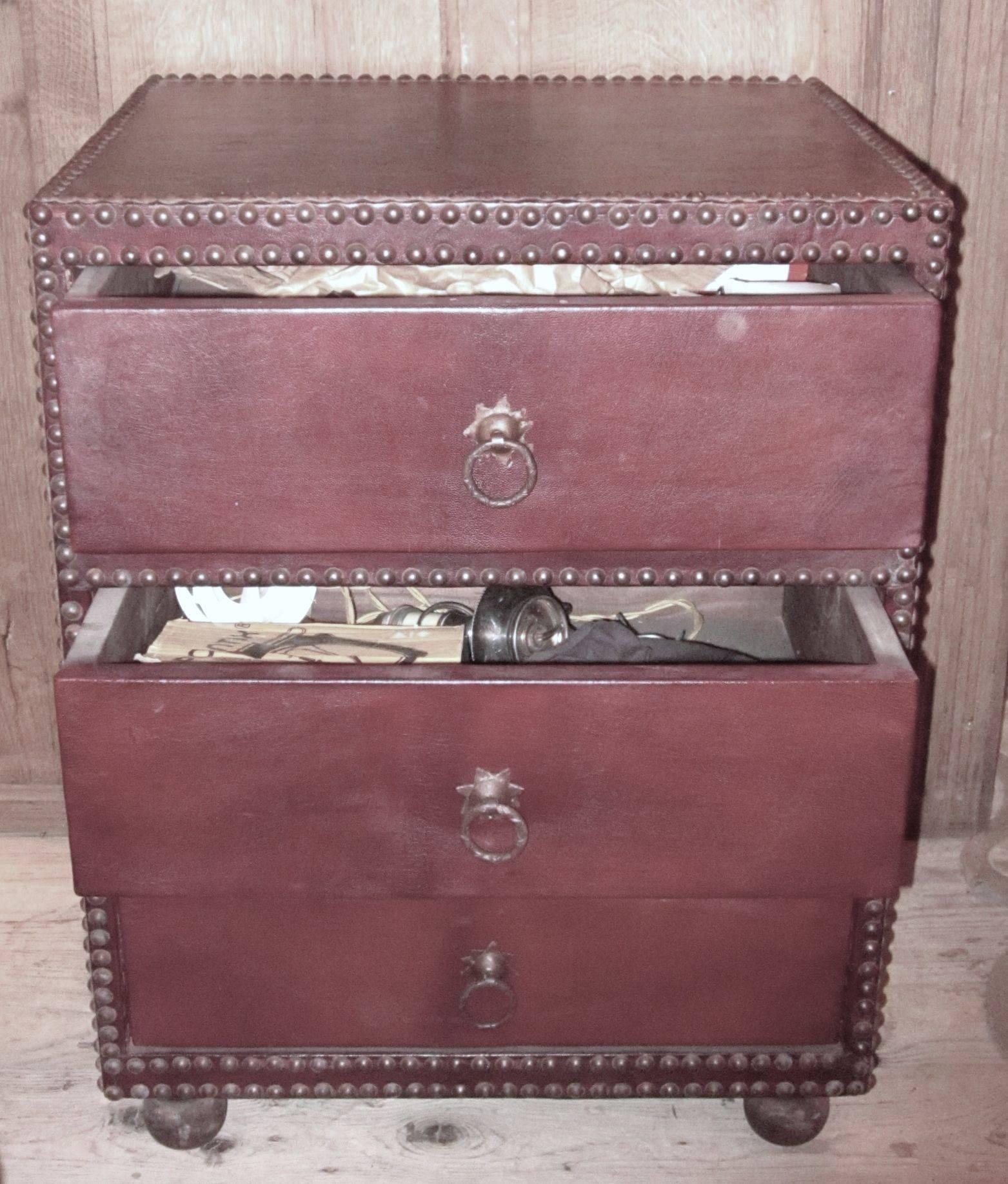 1960s Spanish cordovan leather three-drawer chest or nightstand.
The chest has nailhead accents around the frame and drawers, with brass drawer pulls.
Excellent condition.
 