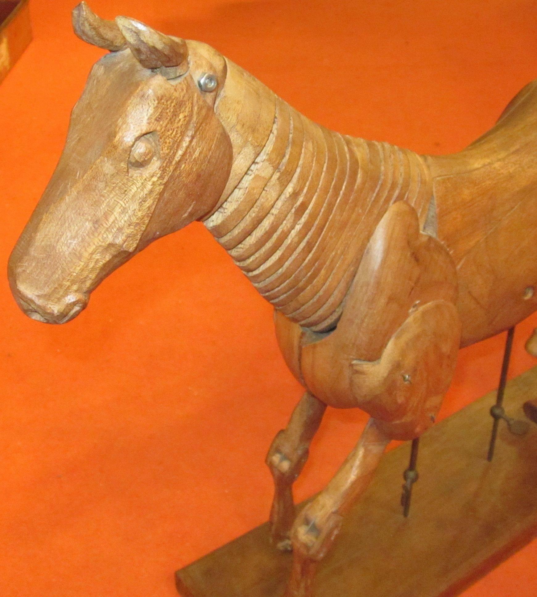 1920s Italian articulated wooden horse sculpture. Horse has movable parts and is in excellent condition.
Note the intricate carving details.
Measures; Stand is 5