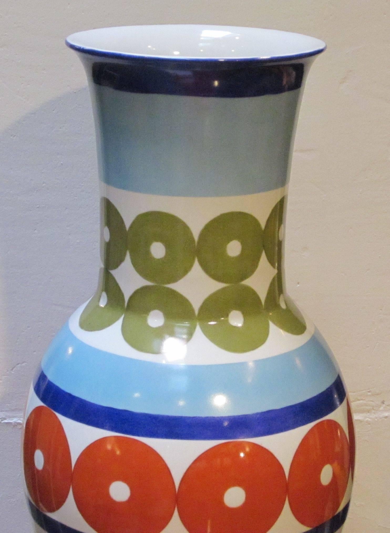 Contemporary Chinese brightly colored porcelain vase by Frederic De Luca.
Pale blue, white with olive and red circles, royal blue base.


