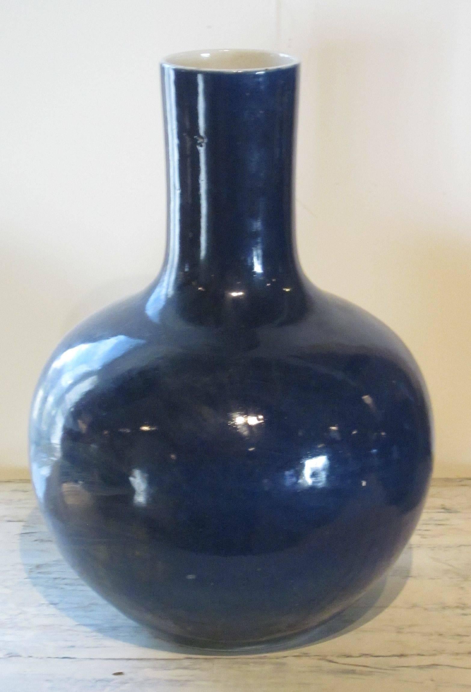 Contemporary Chinese sapphire blue bulbous shape ceramic vase.
Beautiful shade of sapphire with white interior.
Two are available and sold individually.

 