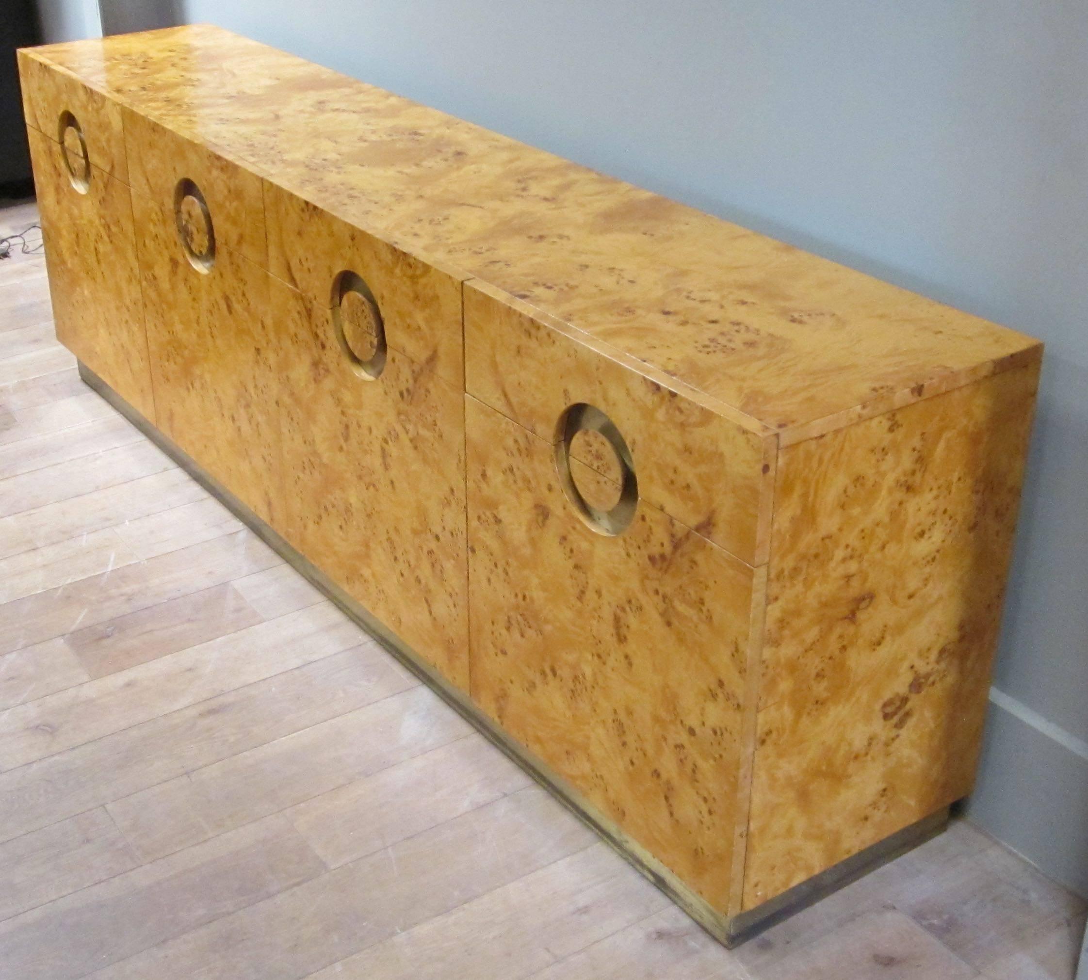 1970s burl birchwood credenza by Italian designer Willy Rizzo.
There are four doors. Four drawers. Brass trim. Brass base. Eight interior shelves.