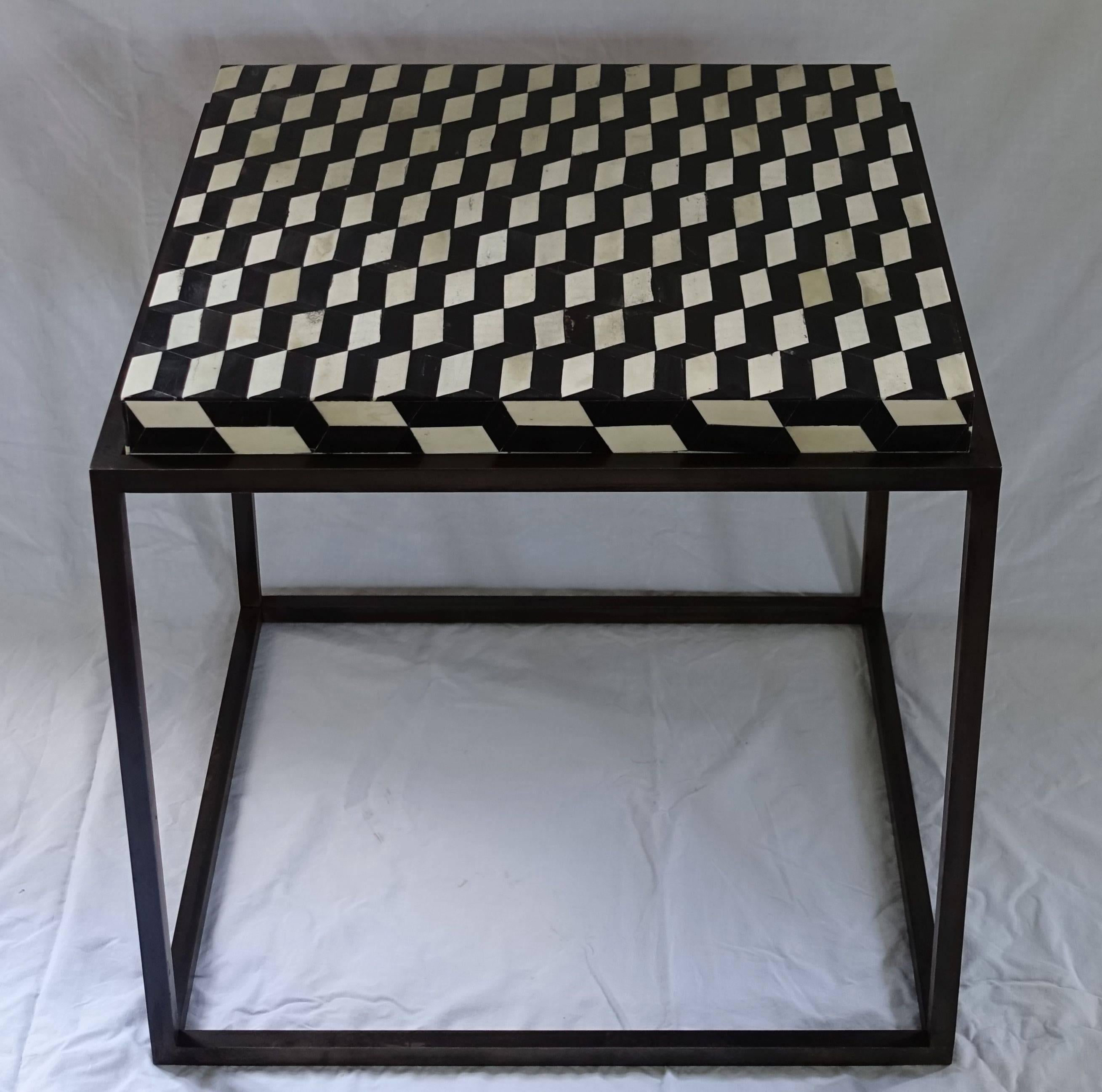 Contemporary side table with a black and white faux bone top on a custom steel base. 
