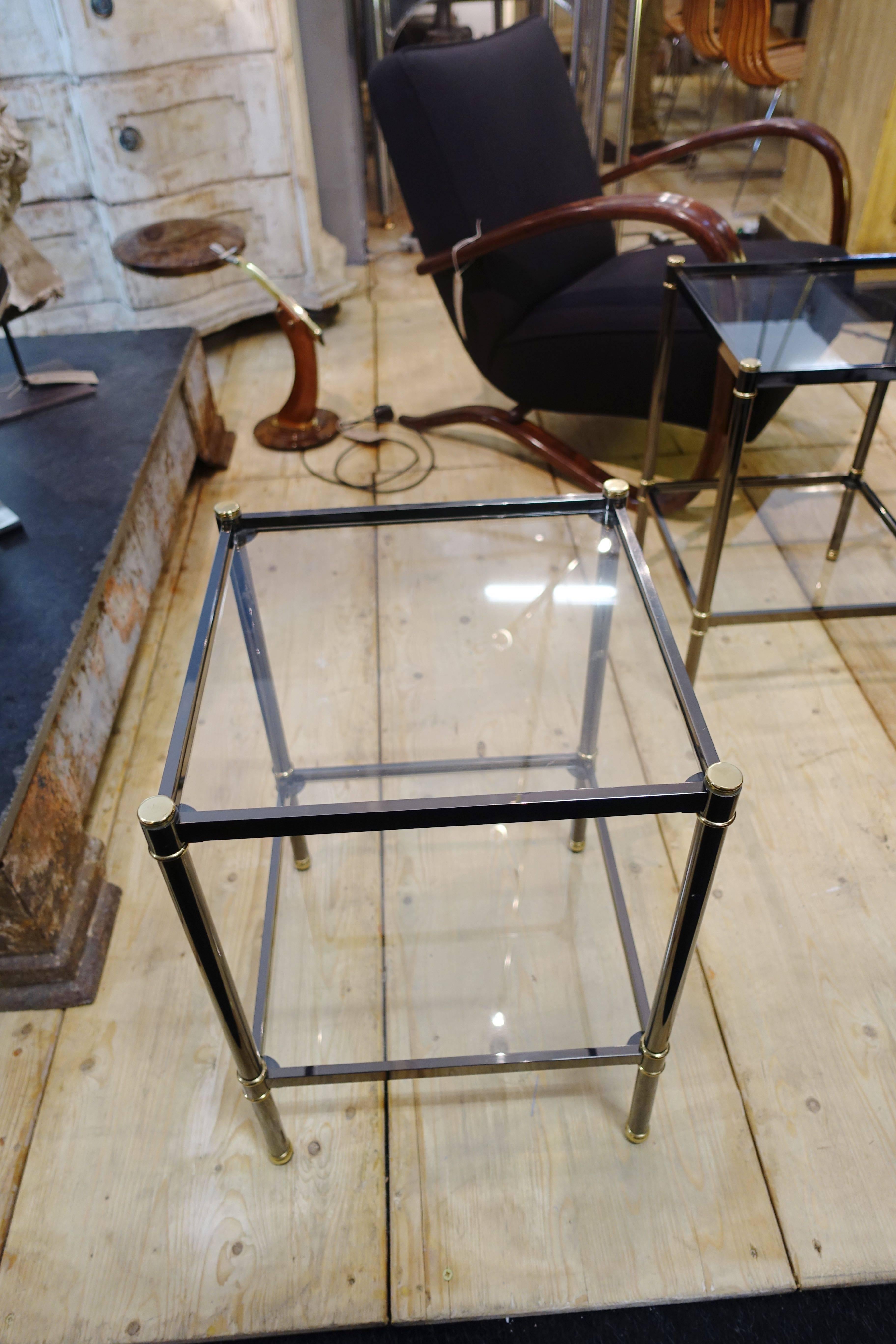 French Mid-Century Modern pair of gun metal side tables with bronze trim.
Two-tier square glass tops.
Excellent condition.