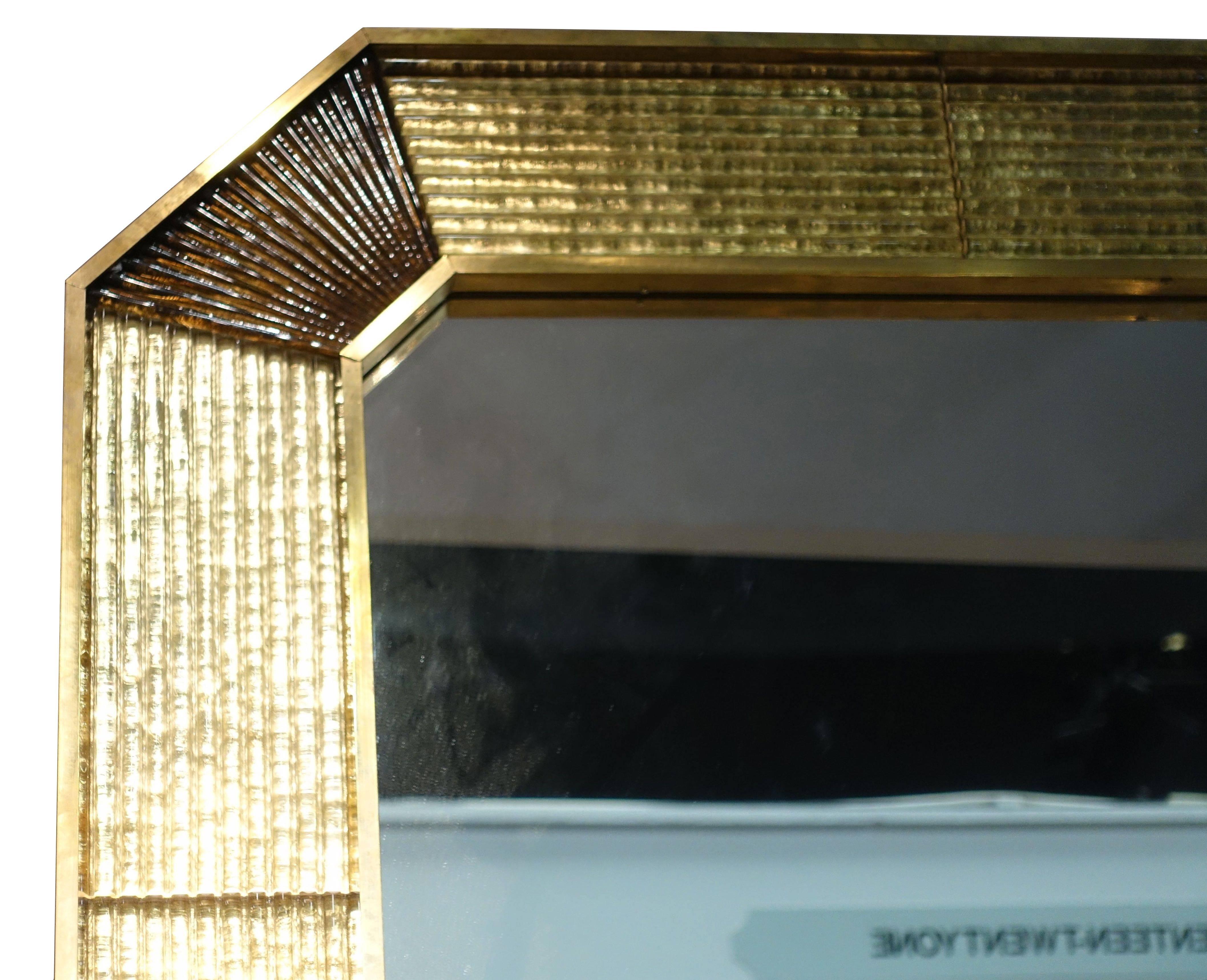 1960s Italian Murano frame mirror with brass trim.
Brown curved ribbed Murano corners.
Original mirror.
Two are available and sold individually.
 