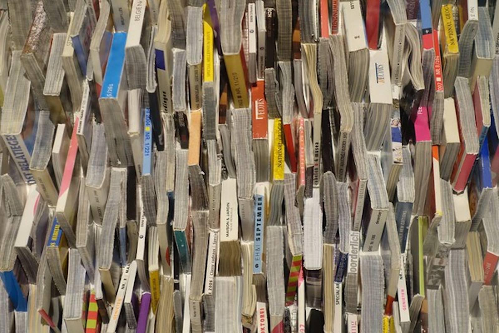 Paper art wall sculpture.
Actual hand folded magazines cut into horizontal triangular pieces and stacked and placed within Lucite box.
Another (P1012) is the same but pieces are placed horizontally.
When hung together they make a very strong and