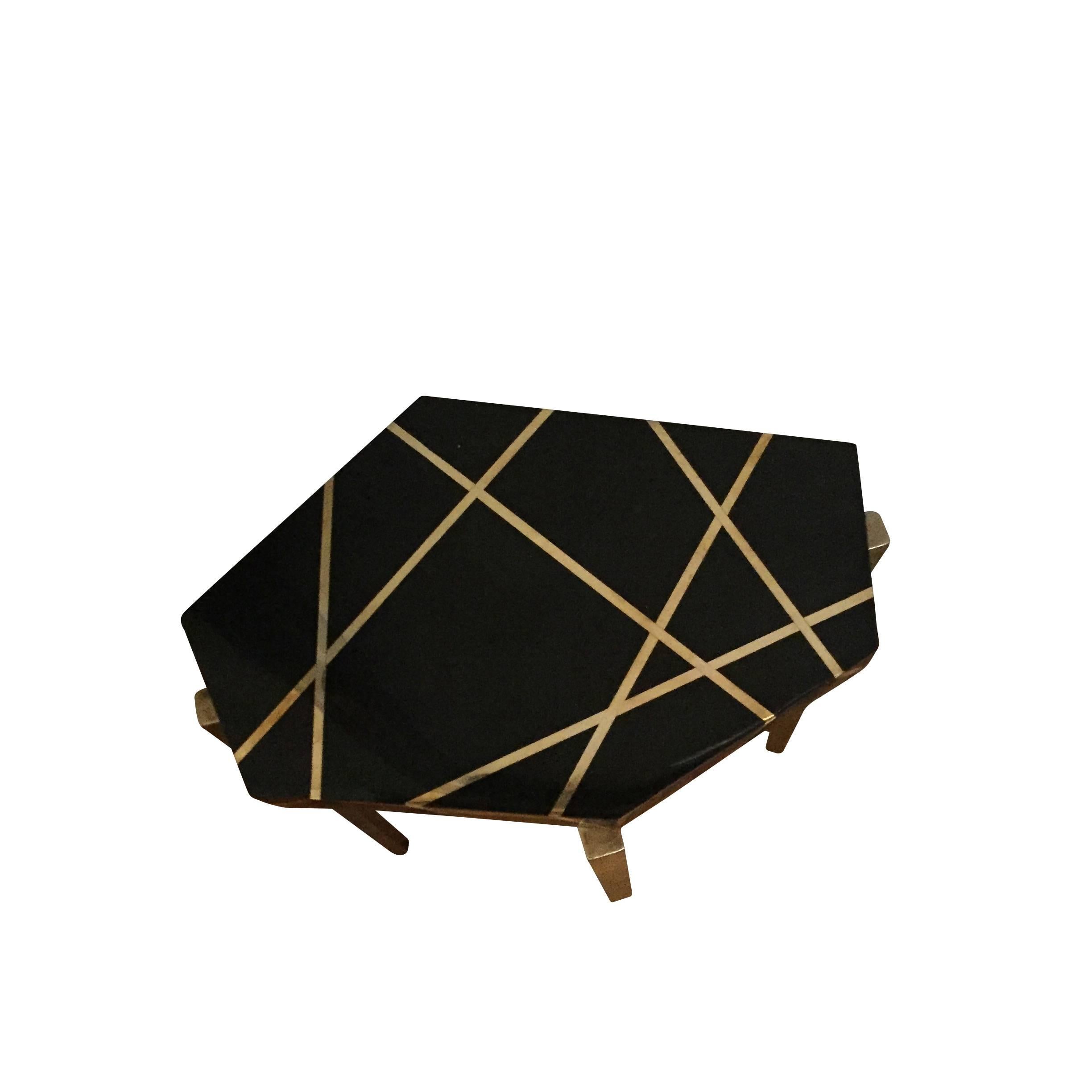 Contemporary French thick black crackle wood top with brass inlay cocktail table.
Hexagonal shape top with tapered bronze legs.
          