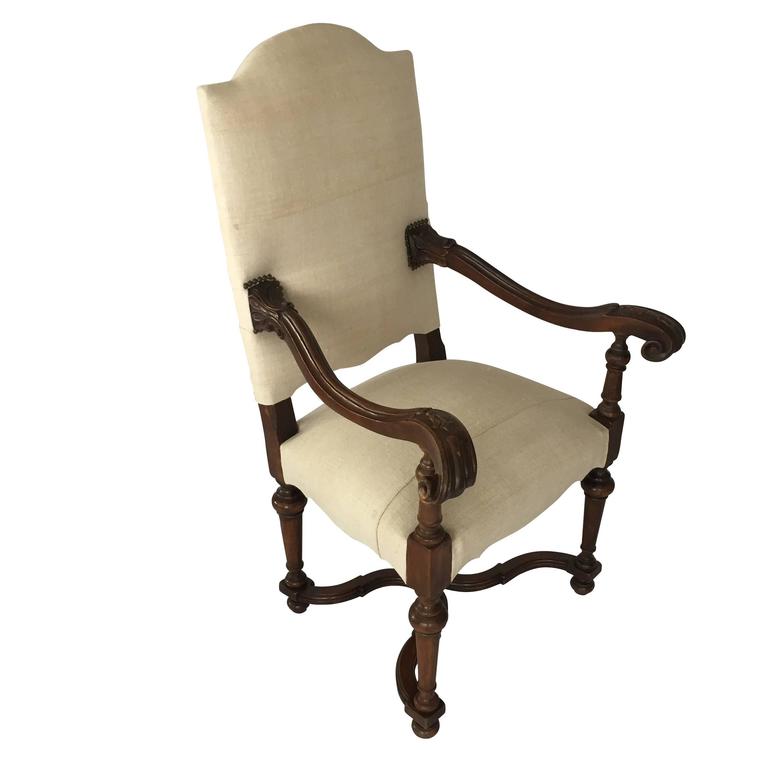 1920s Classic French design with decorative carved wood finial at base side chair.
Carved walnut side arms and base.
Newly reupholstered in vintage handspun linen.
Decorative curved details at apron.