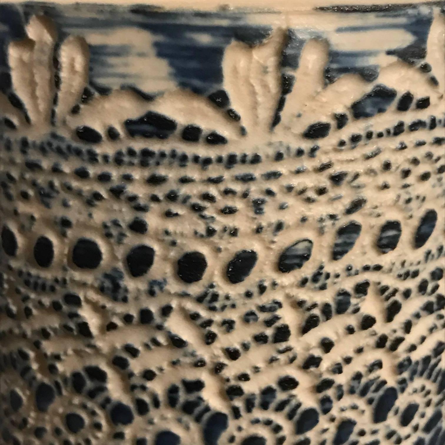 Contemporary Thailand cylinder shaped vase with indigo color blocked pattern.
  