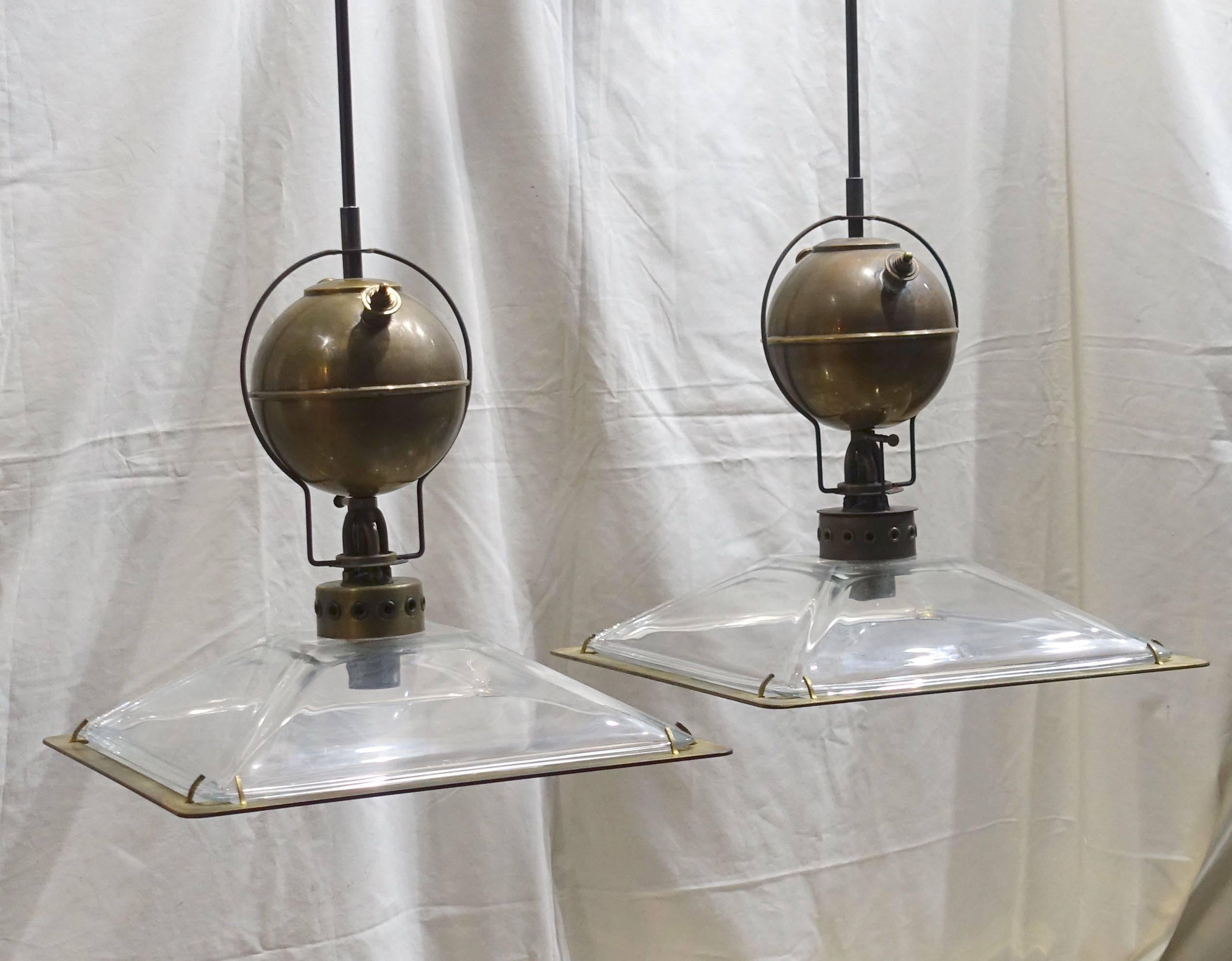 Italian very decorative pair of Industrial light fixtures. Note the decorative brass details and square glass shades with metal trim.
Metal rod and cap are included.
Fixture only height is 15
