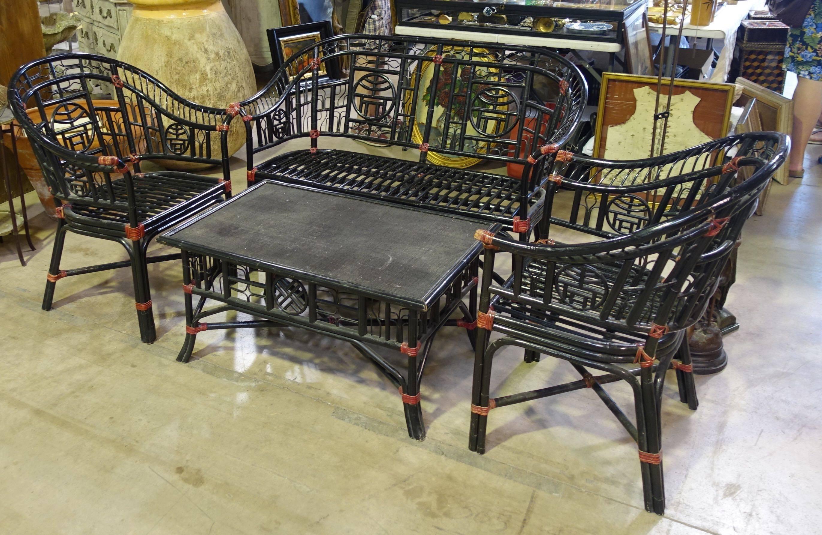 Black bamboo four piece seating group, circa 1960. Red accents. Asian motif.
Perfect for a garden or sun room. Indoor or outdoor patio.
Sofa measures 50 W x 25 deep x 35 BH x 20 SH. The chairs measure 28 W x 25 deep x 35 BH x 20 SH. The coffee table