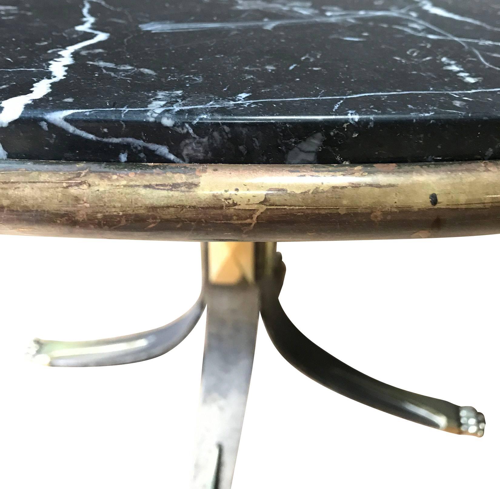 Mid-Century French unusual natural steel base with black or white vein marble top side table. Can also use as a centre hall table.
Brass apron.
Brass claw feet.
Brass details on pedestal base.
