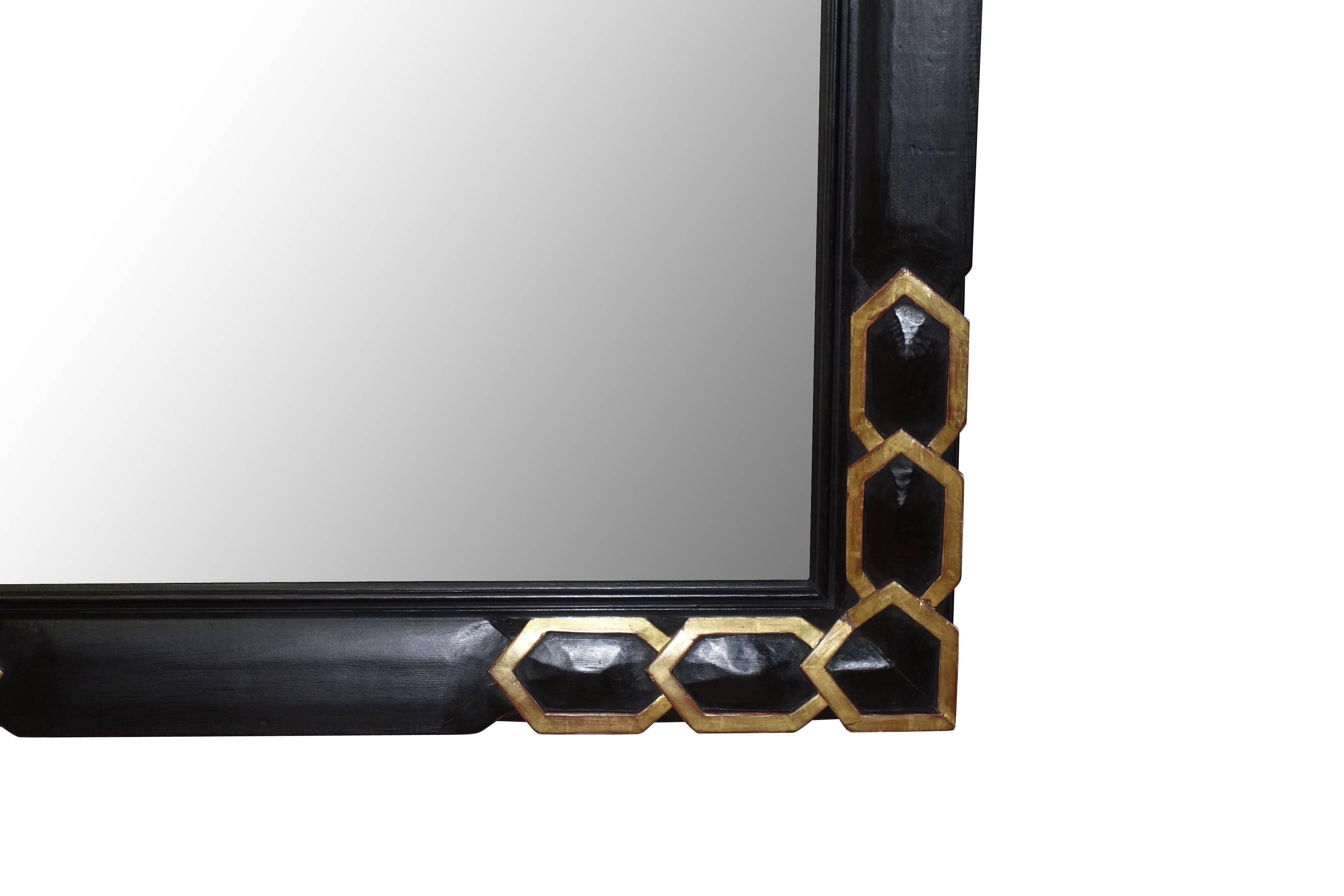 1930s French interlocking gold gilt rings at the corner of extra large ebonized frame mirror.
New mirror.
