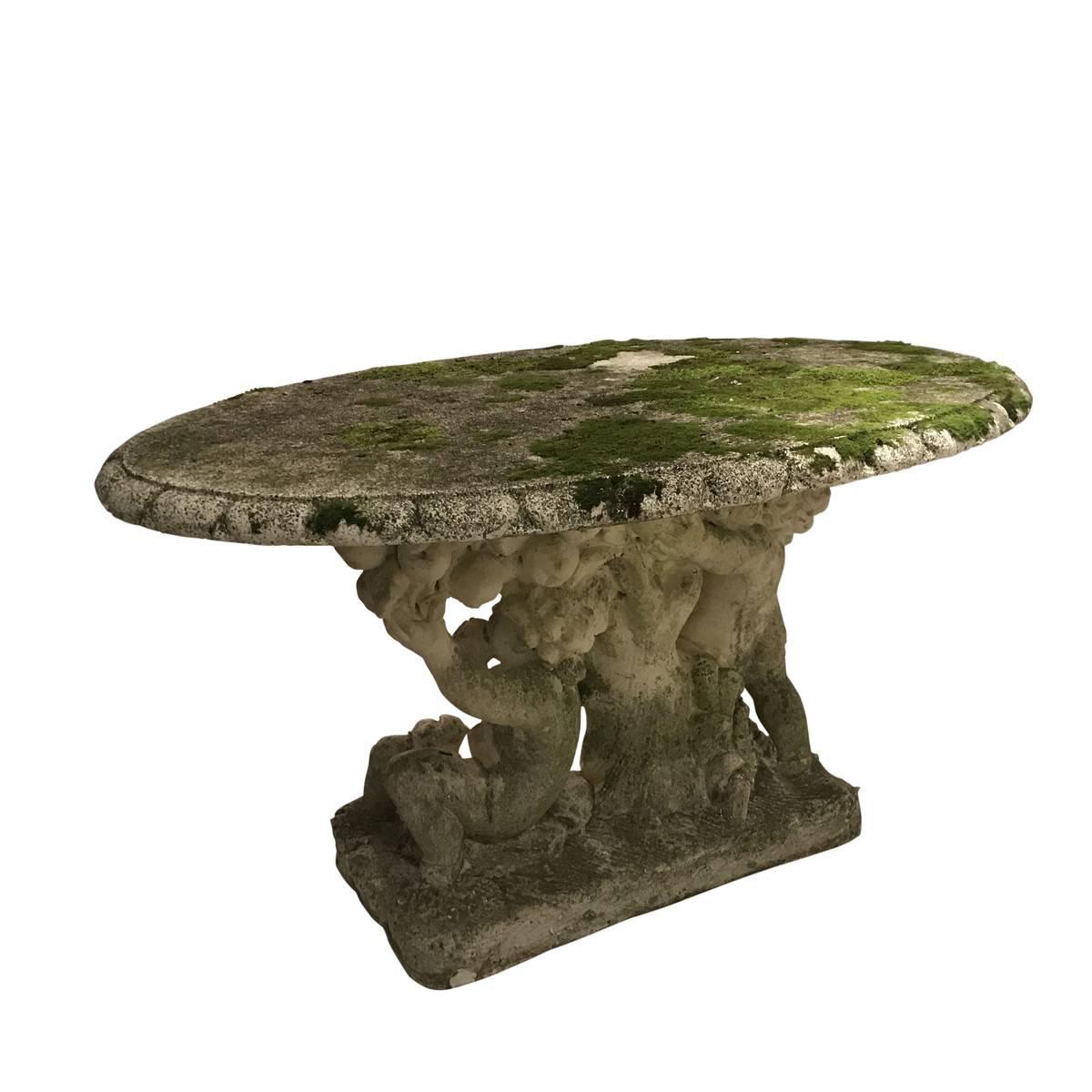 1920s Italian embracing putti's are the base to oval reconstituted marble garden table
Natural moss and spores embedded in stone provide beautiful aged patina.
 