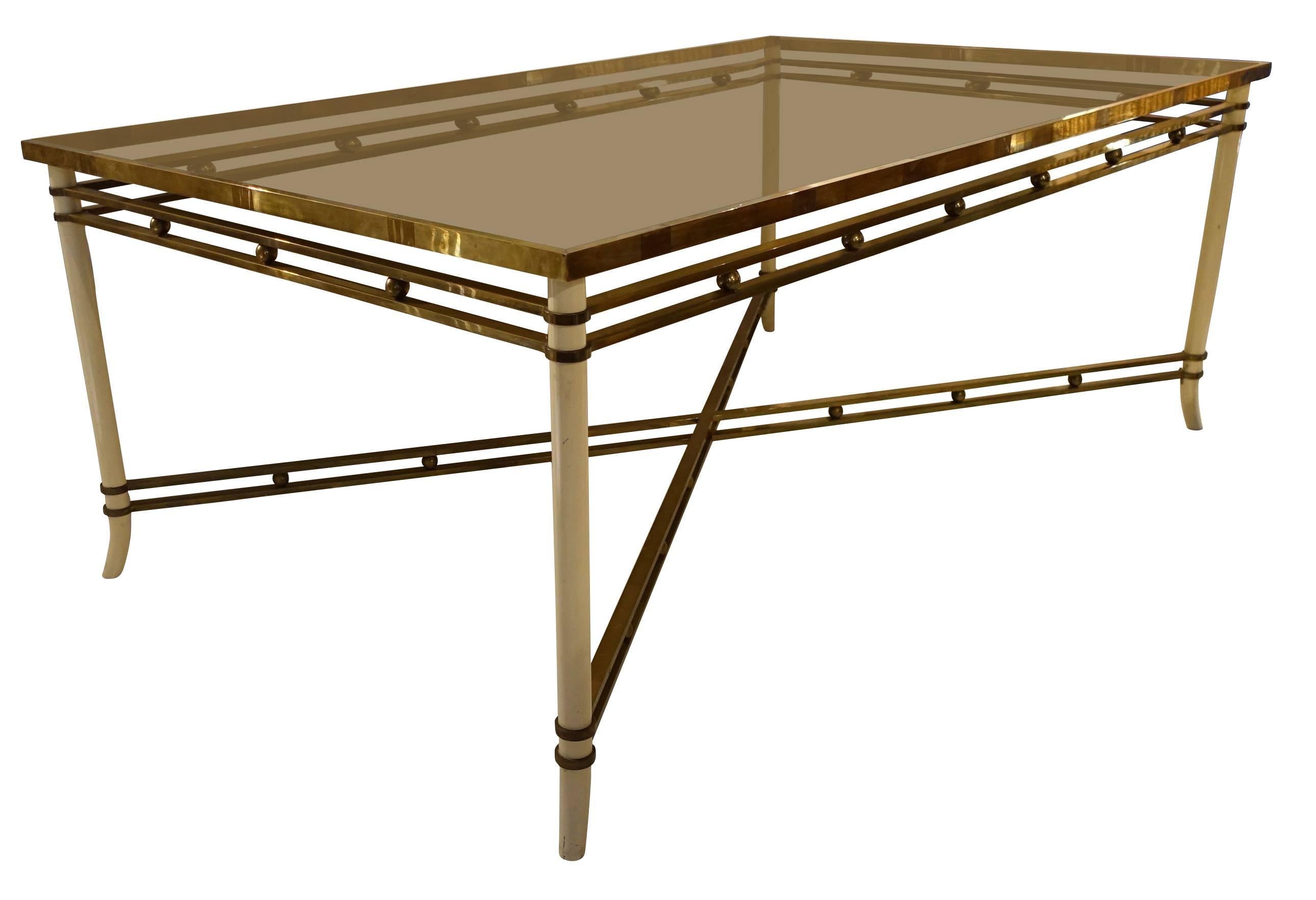 Midcentury French cream colored metal legs with brass details.
Smoked taupe glass top.
Decorative small brass balls placed along apron as well as cross stretcher of table.