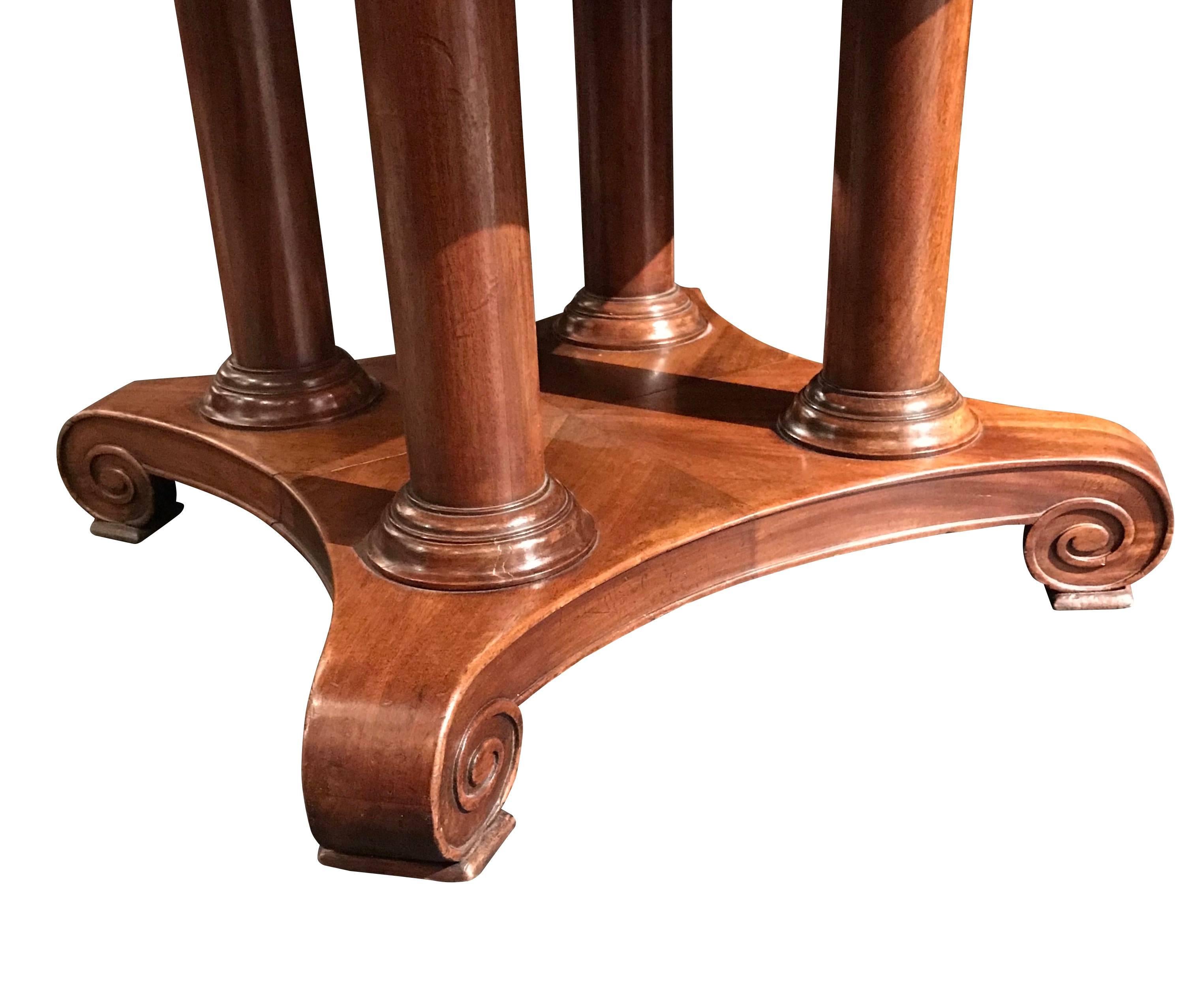 19th Century French, mahogany table that would make a great center hall table or a side table. Note the four columns and the varied finish on the four sections of the base.