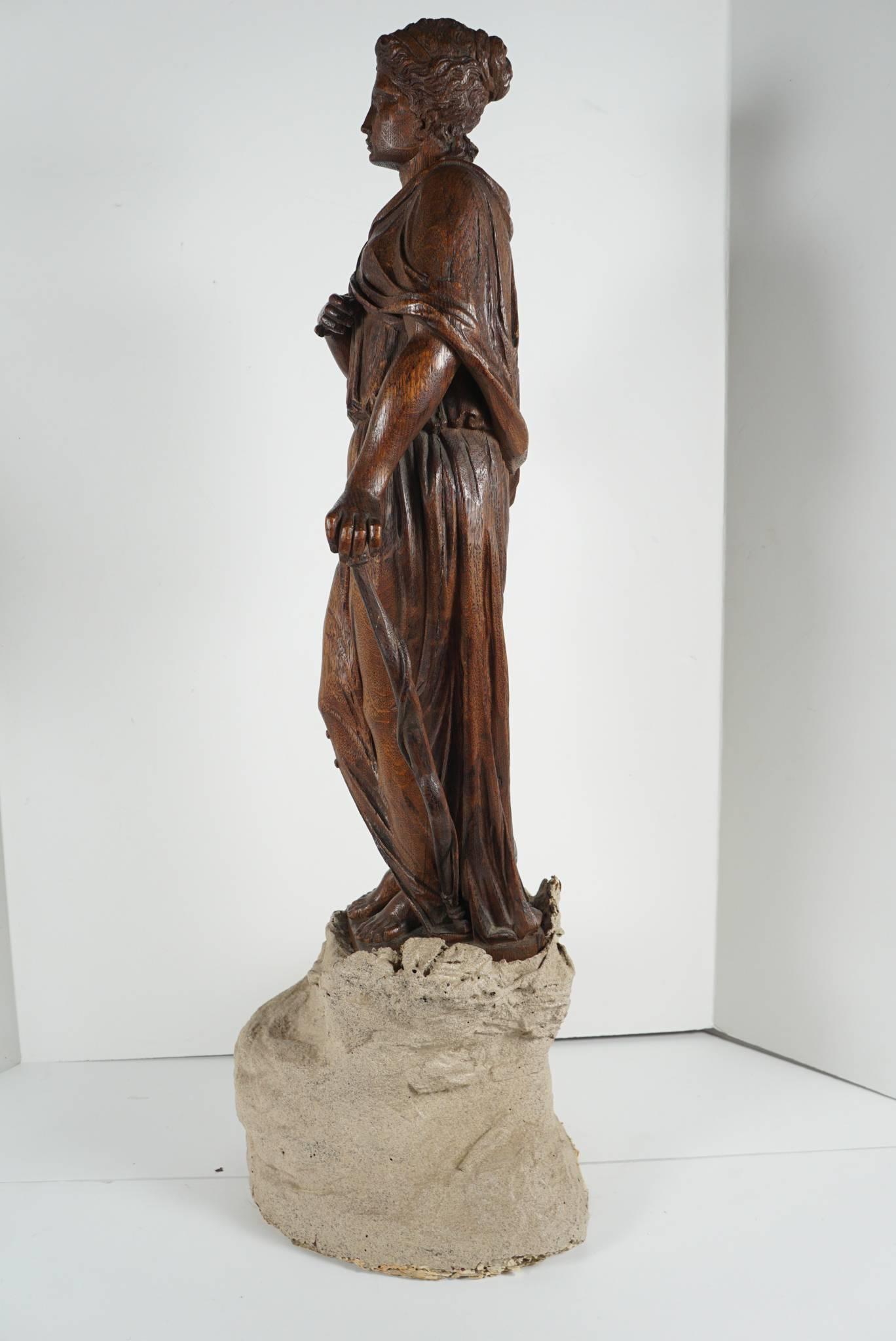 This figure carved to represent Diana the goddess of the hunt comes complete with bow. Carved in a Baroque revival style in France circa 1880 she may have once been a newel post finial. The carving has a large wooden section designed to set down