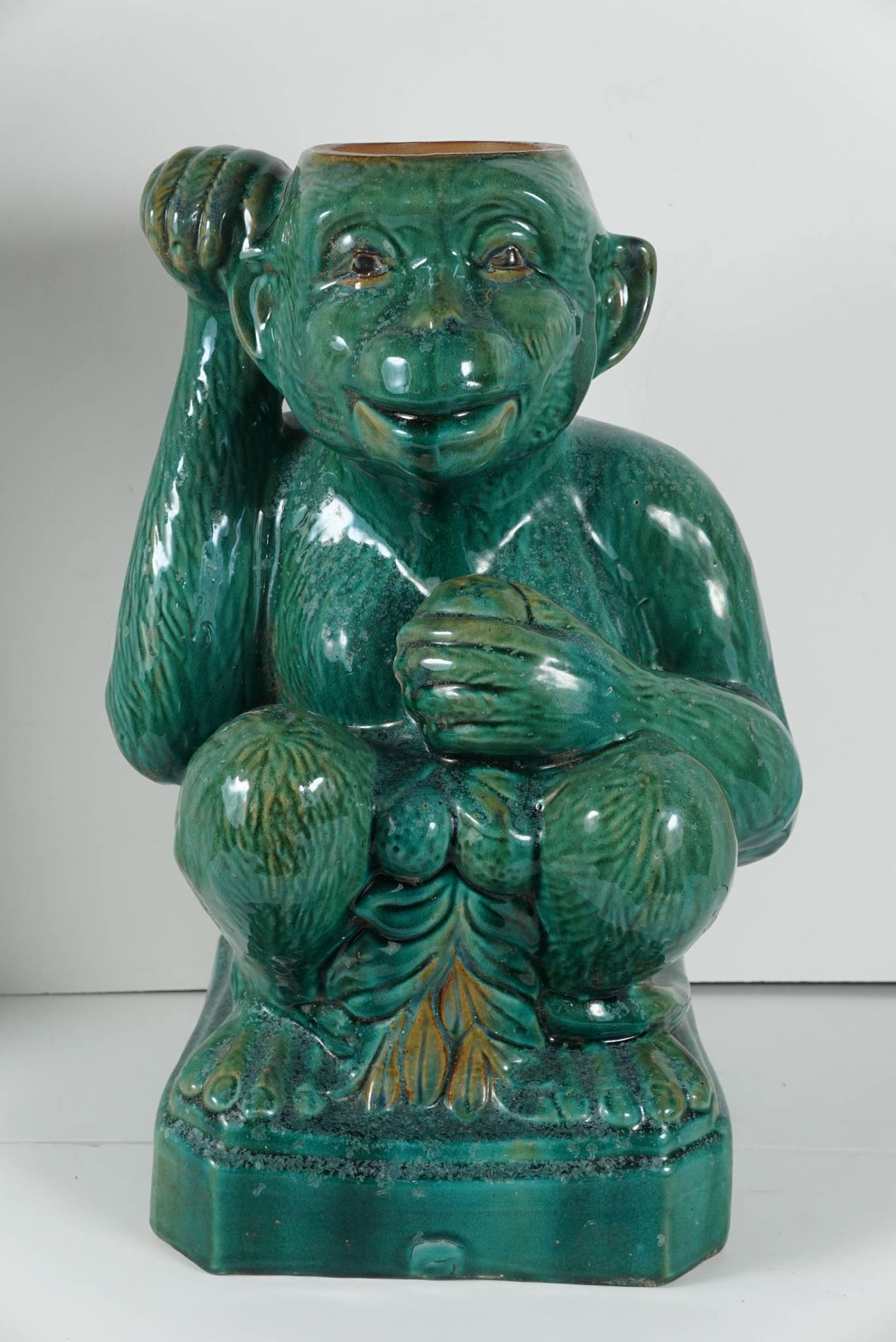 These two different monkeys from the estate of Clare Kellner.  One is an umbrella stand the other just a decorative companion are circa 1950. The figures are lively and realistic in form with detailed facial expressions and poses. The glazed green