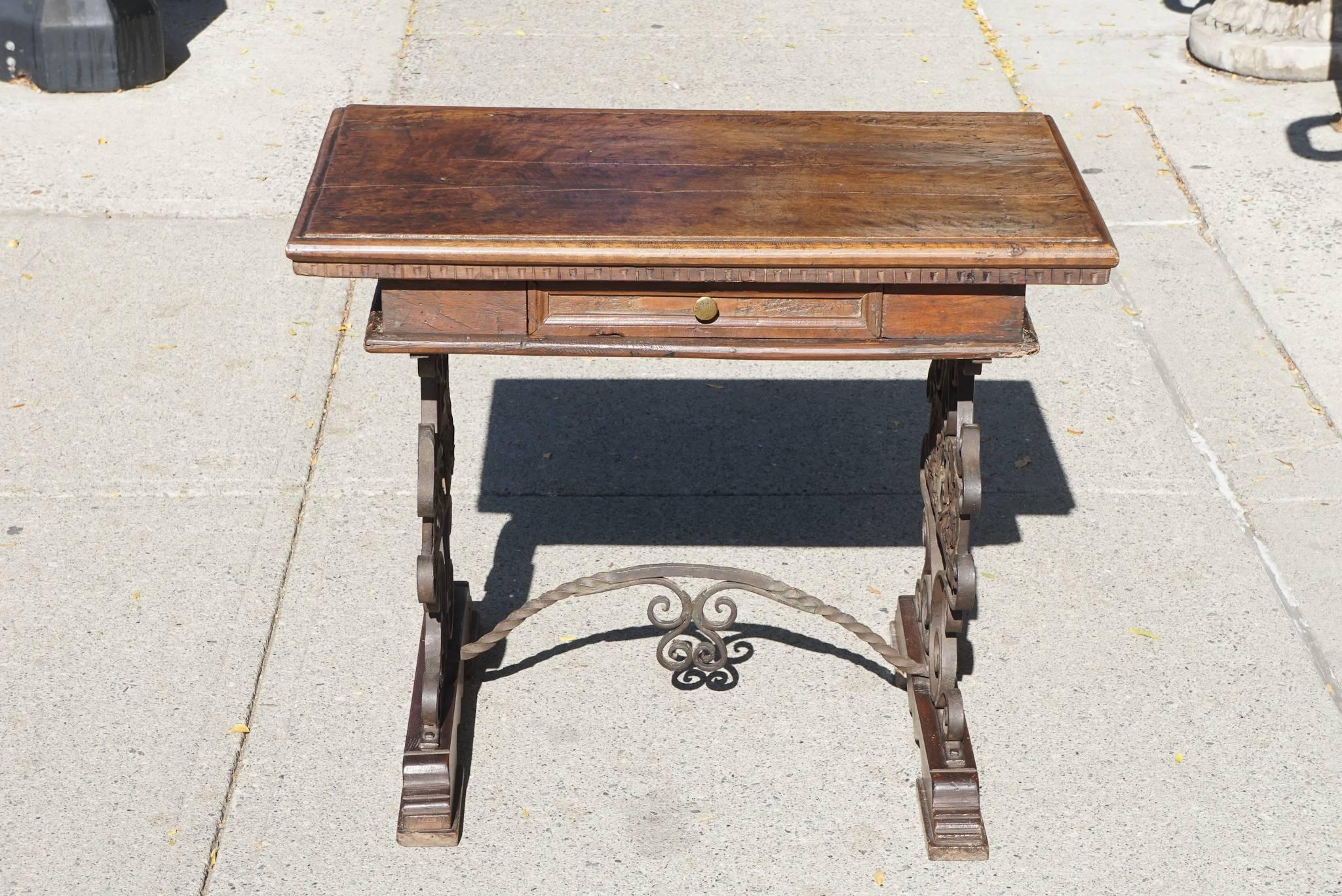 This nice low table crafted from thick walnut and iron is Italian and made, circa 1890. The table is in the style of the Renaissance but was made to satisfy the growing late 19th century resurgence of that periods artistic flourishing and the