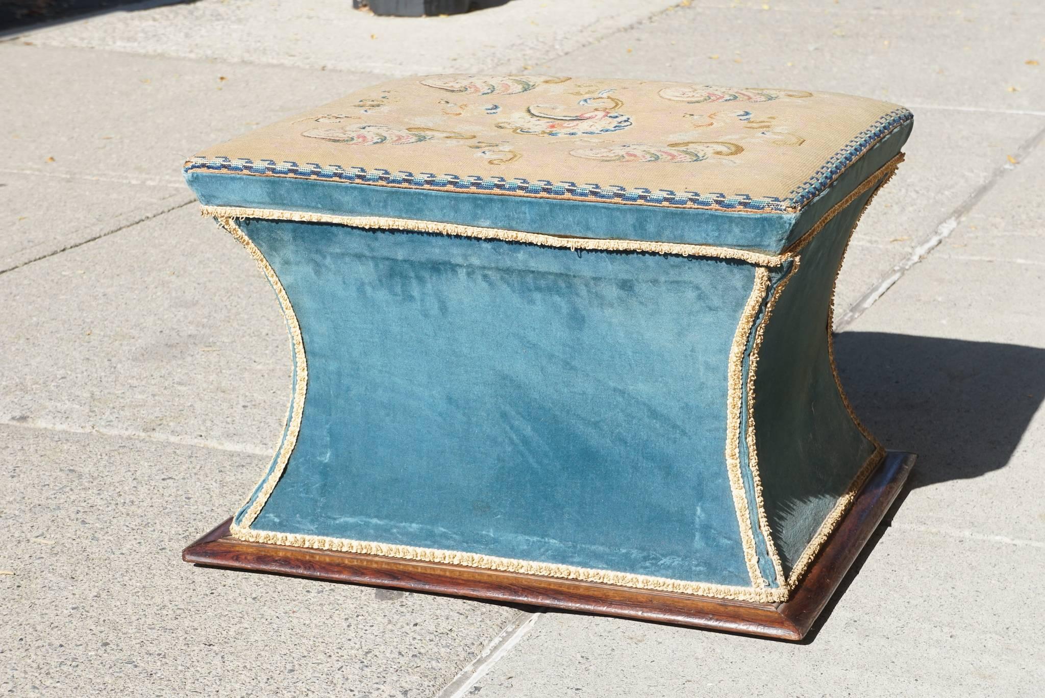 This very good upholstered storage ottoman was made circa 1820 and is fully branded with the maker's name and address (see images 9 & 10). The current upholstery is from the late Victorian era while the needlepoint top is of a slightly earlier time
