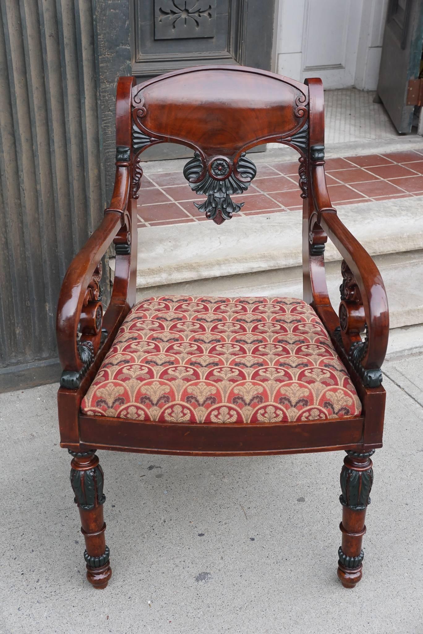This finely carved mahogany armchair is from the 19th century. Made in Russia around 1870 the chair is further enhanced with a verde antique paint work resembling ancient bronze on the carved elements. This makes the chair very masculine and formal.