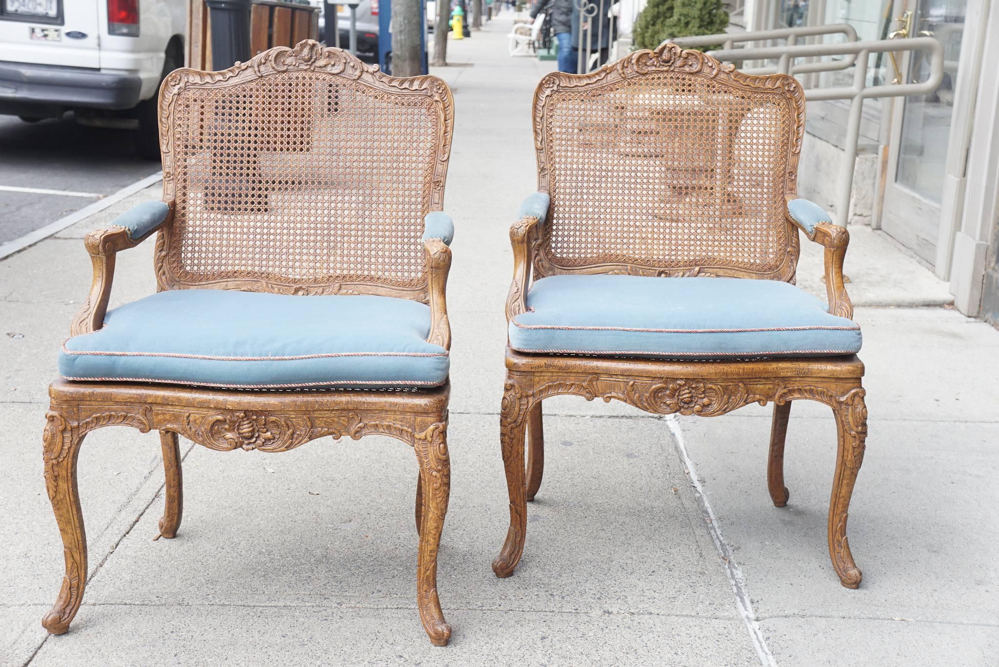 This pair of chairs in carved oak are made in the Regence style and are finely carved. Generous but not over scale and comfortable the chairs reflect the attention to detail but subtle balance often associated with fine French furniture. Made at the