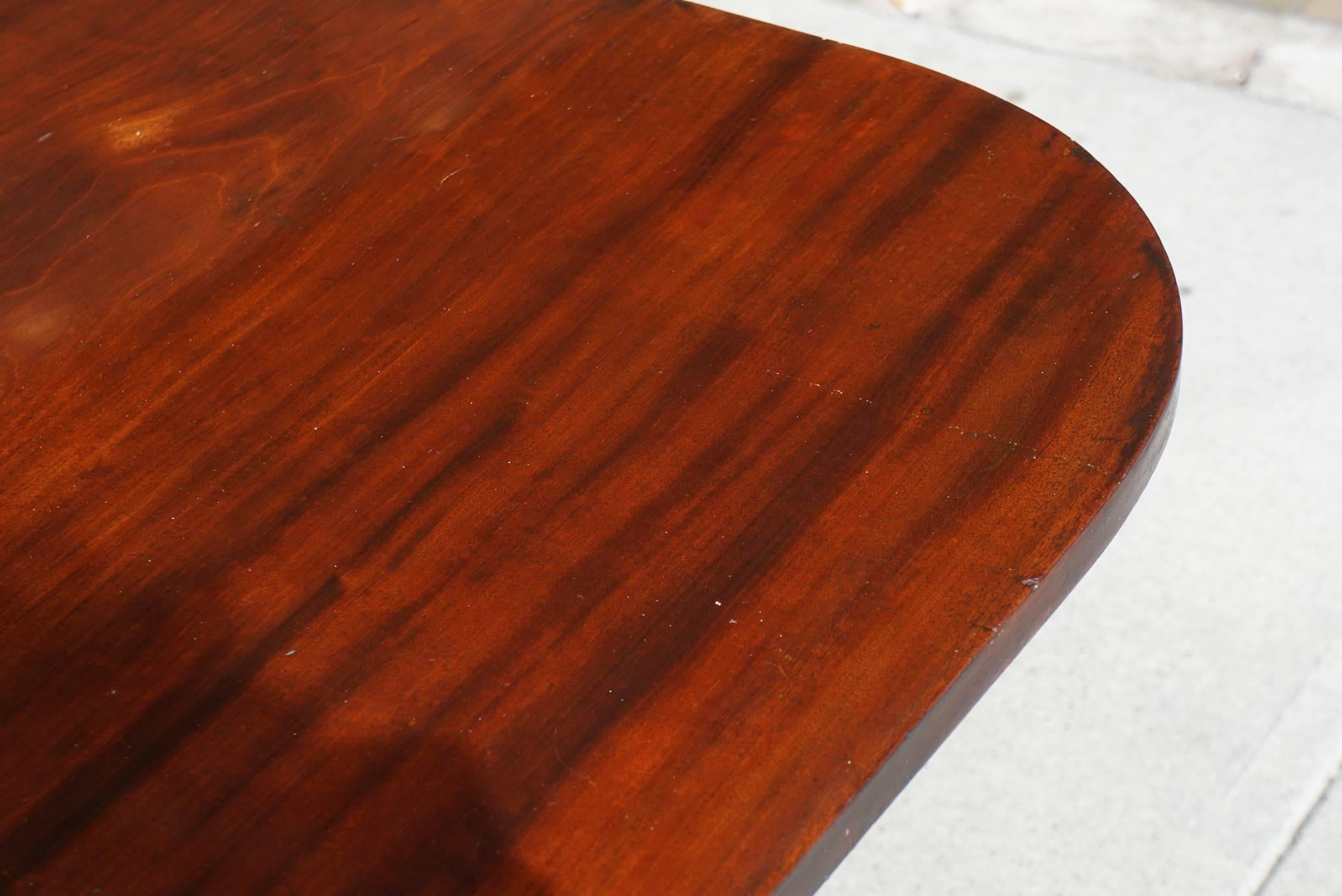 This fine mahogany table is of American origin but we are unsure of its place of construction. The top is as old as the table base but is most likely from another table making actual determinations as to its origins hard. The top is made of three