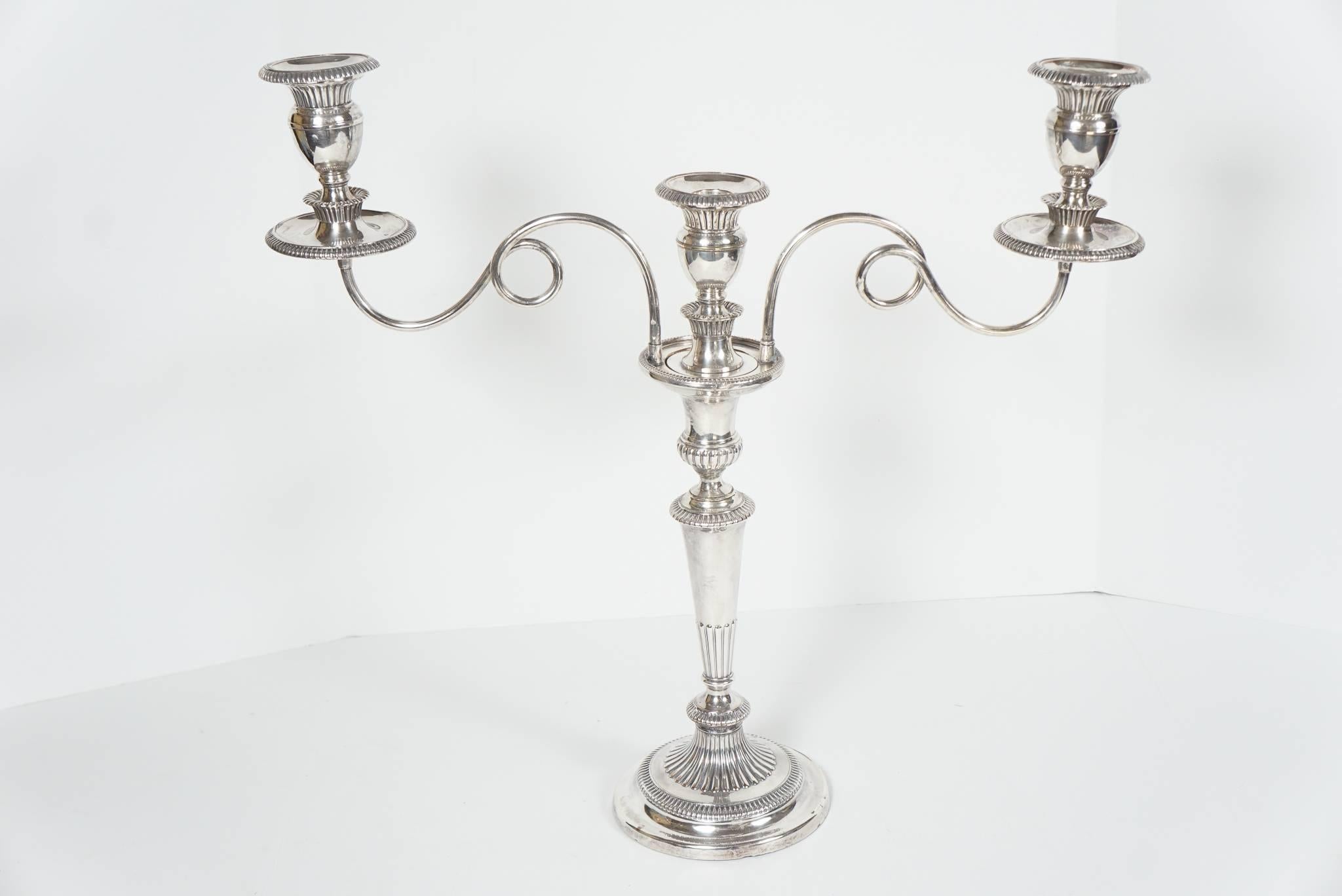 This very nice pair of Sheffield silver plate candelabra are of excellent form and quality. The early use of the medium created a vast Expansion of the ideals of table service and how dining made the acceptance of social graces open to ever larger