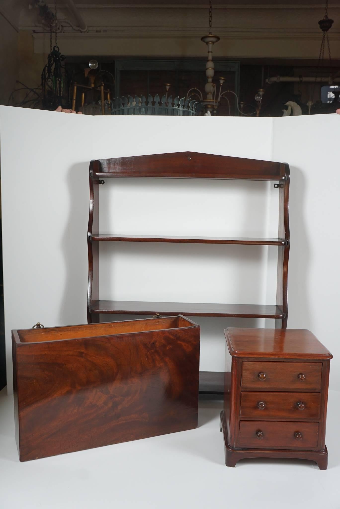 This collection comes from the estate of Paul & Bunny Mellon from their home Oak Spring Farms in Charlottesville Va. This grouping consists of a Mahogany hanging shelf from the late regency period. Designed with four shelves used to display small