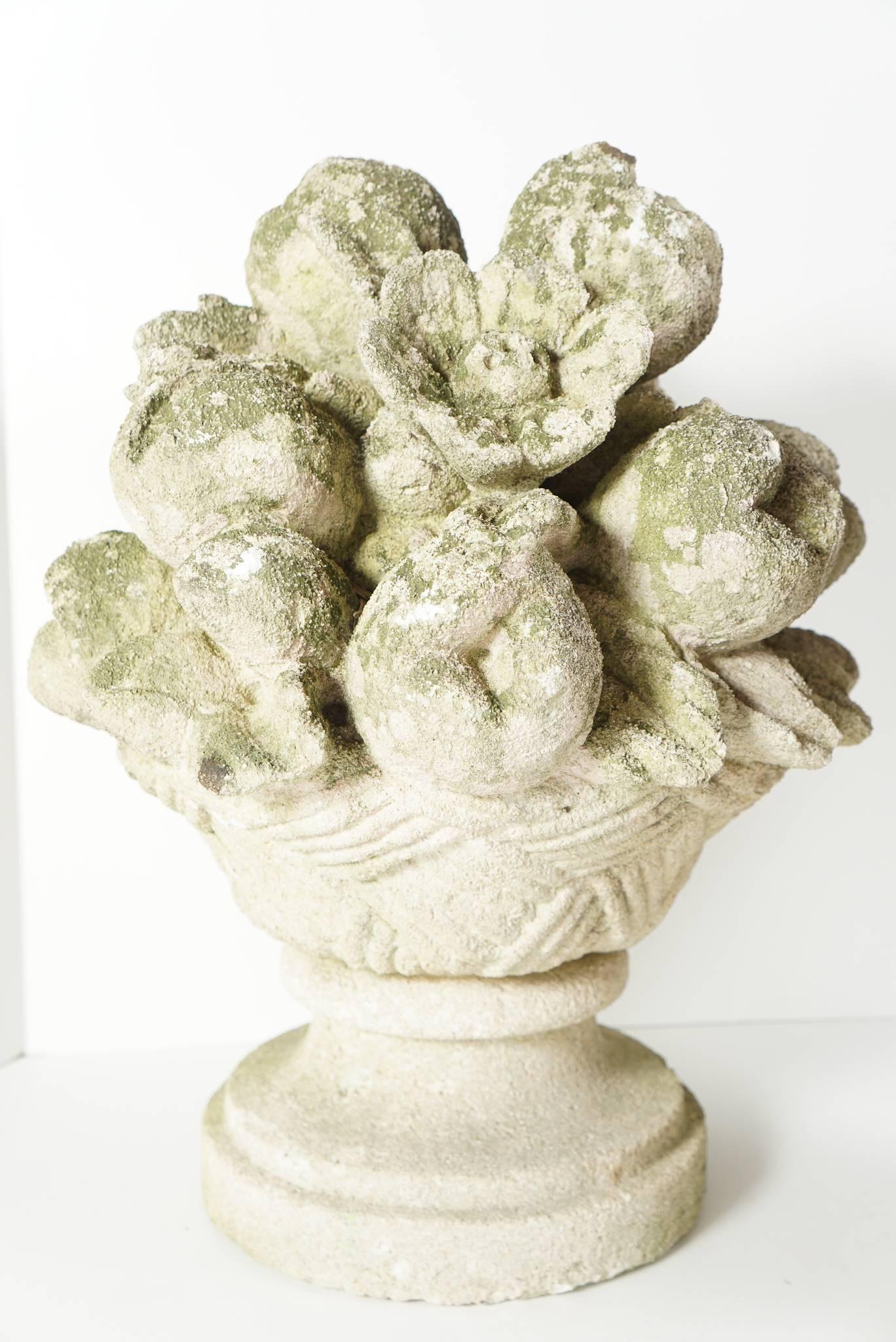 This vintage pair of carved tuffa stone baskets was made circa 1930. Carved in deep relief representing flowers and fruit piled in a decorative compote giving the impression of nature in all its abundance. The pair retain a nice old surface being
