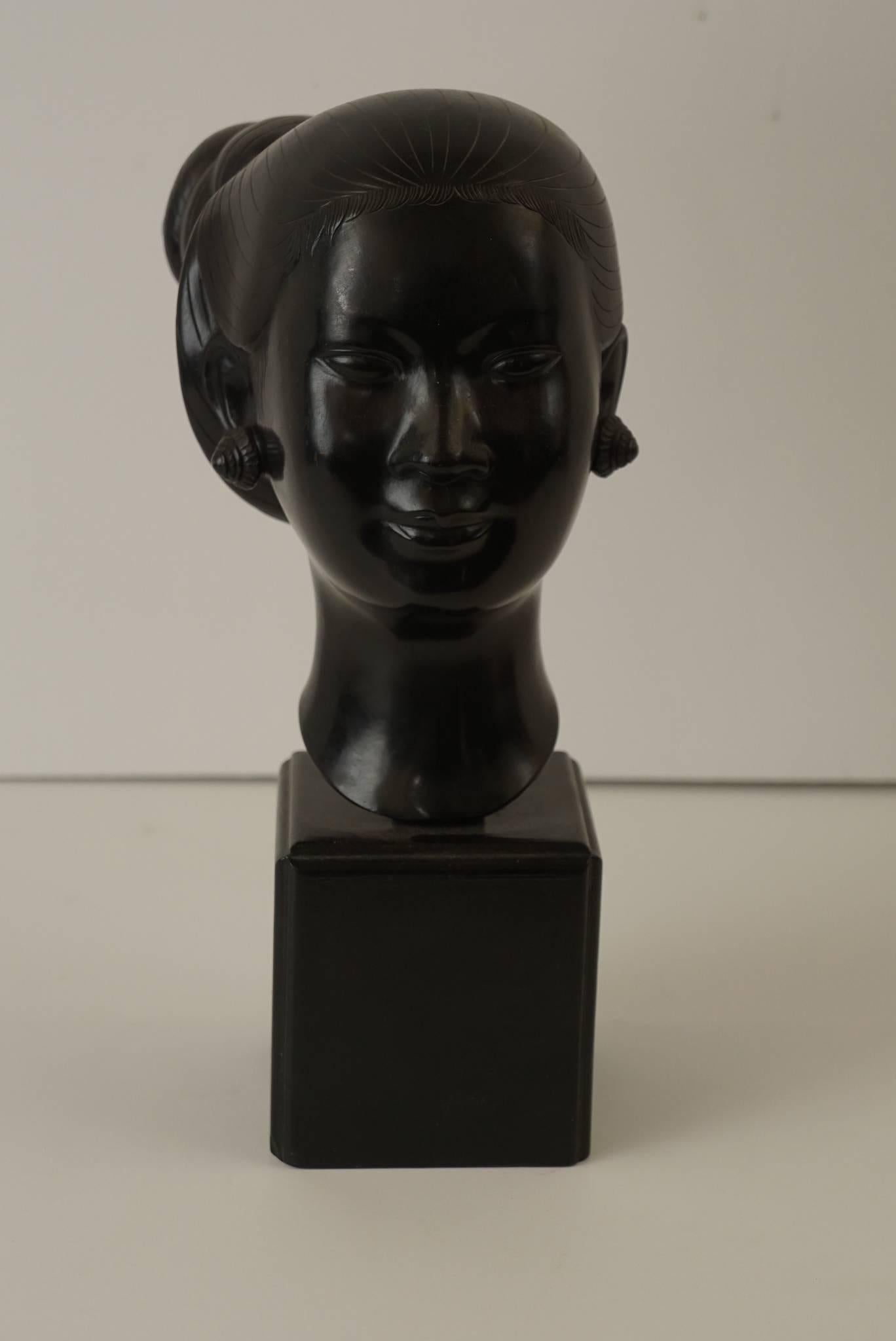 This bust of a Laotian Women is one of the artist most recognizable sculptural works.The distinctive and detailed work is done in a modern style and has an affinity to the best works shown in Europe particularly bronzes done in France and Germany