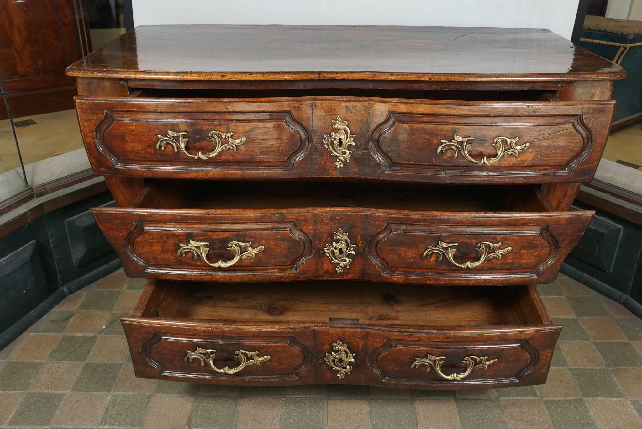 This very fine walnut commode bordelaise comes from France. Stained in a very deep warm brown, Provincial in style and created circa 1750 during the reign of King Louis XV this commode retains a wonderful rich color and style. The carving is deep