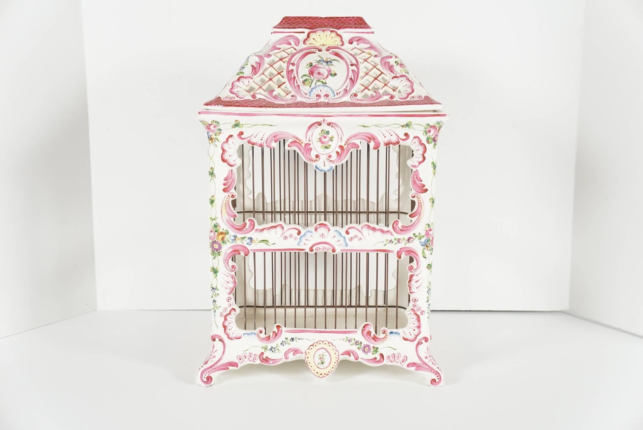 This fine working bird cage made from hand-painted and glazed faience was made in France during the 1960s. Produced at Atelier De Sergies one of Frances finest ceramic firms with a long and storied career. The top is removable and the door to the