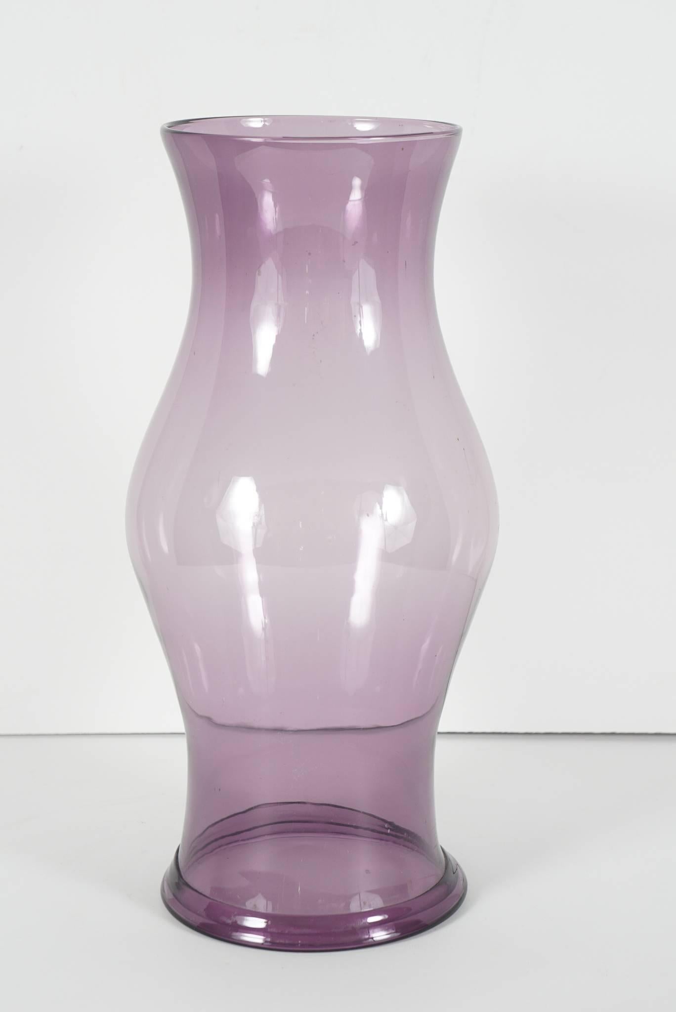 This very nice pair of handblown glass hurricane shades were made in the early 19th century. English in manufacture the color is a rich and lovely shade of purple. Shades like these were designed to emit light but reduce drafts and help maintain