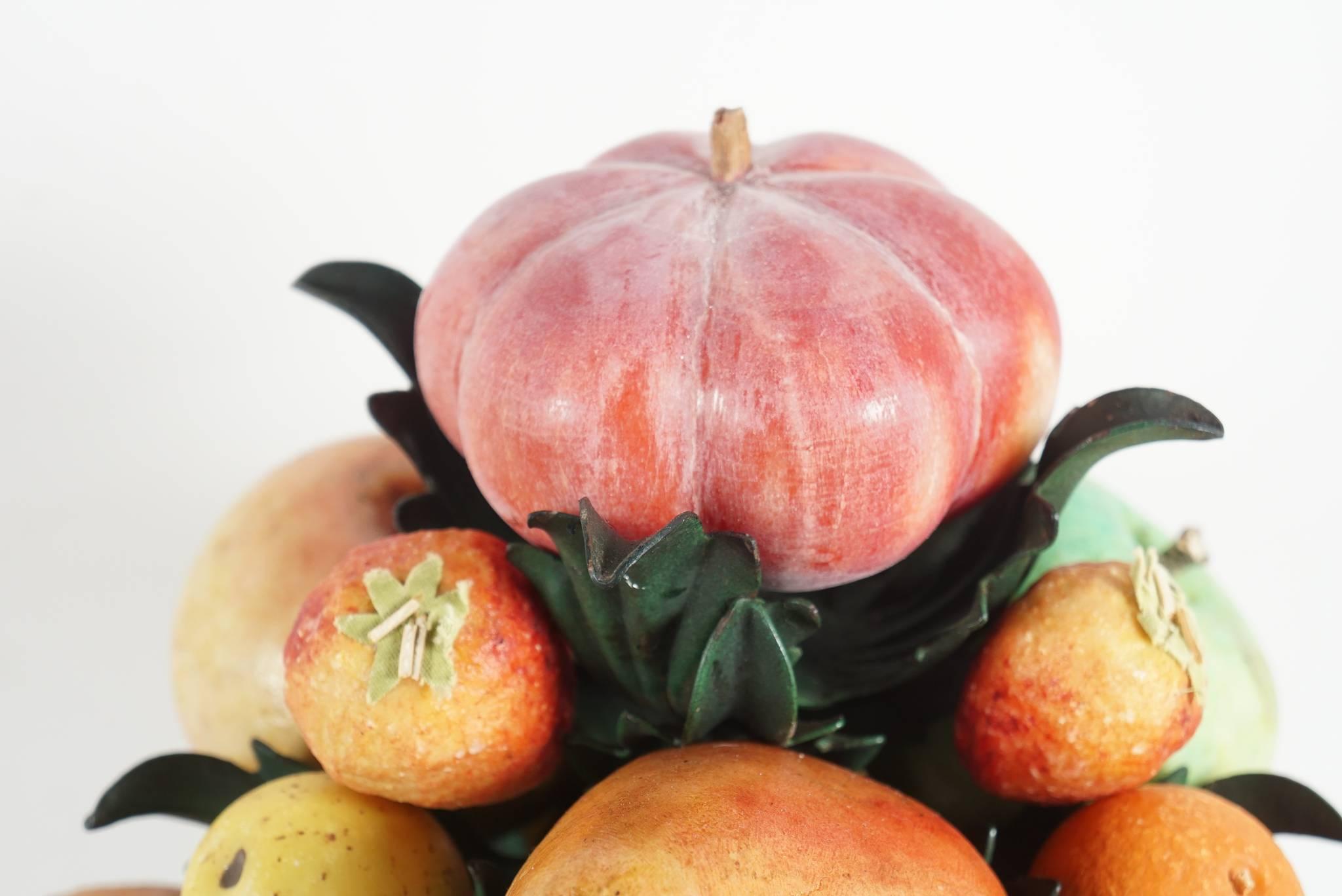 This French tole peinte leaf patterned stemmed stand on pierced base is filed with old Italian carved and painted marble fruit. The fruit is in several naturalistic sizes ranging from very small to large and many pieces are further decorated with