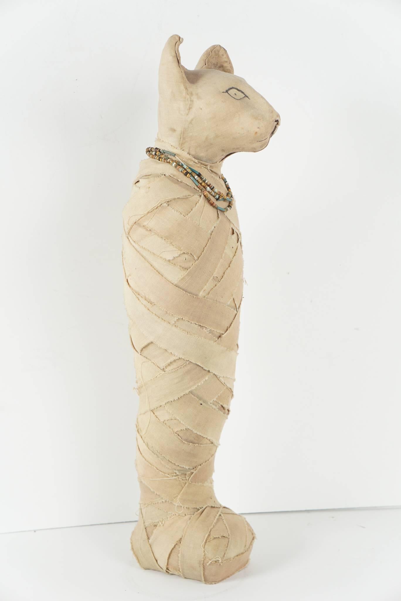 This object is made to resemble mummified cats worshiped as gods and ambassadors from the underworld. Made in Egypt to sell to the tourist trade but not made as an intended fake antiquity this item is a rare survivor from at least 100 years ago and
