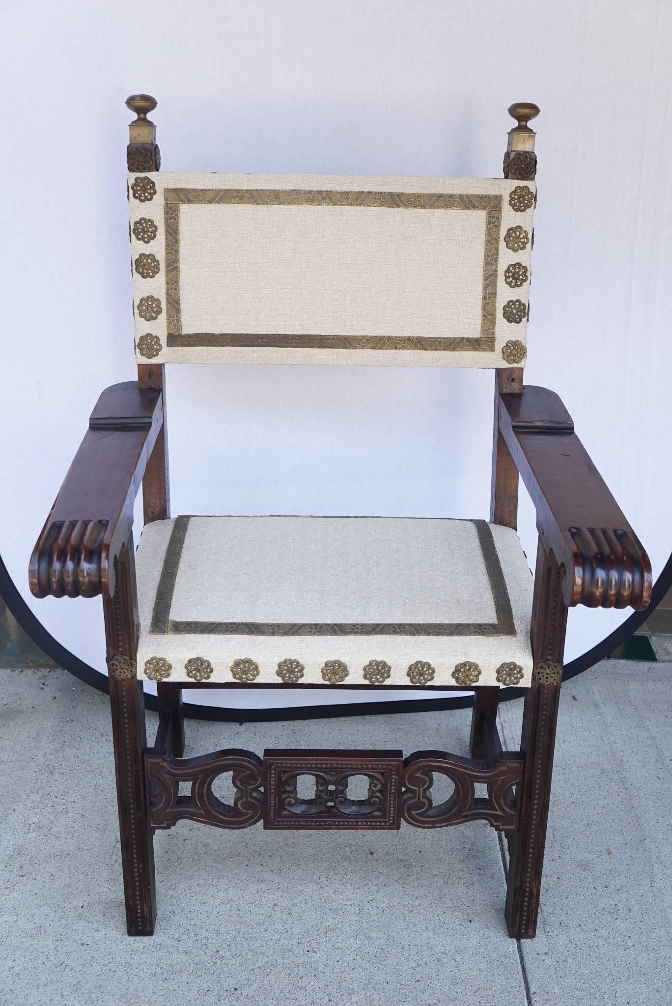 This lovely large single chair made in Italy perhaps the Tuscan region in the late 18th cnetury is crafted from fine walnut with a deep rich color and patina. The large deeply carved and decorated arms join uprights that are also carved and