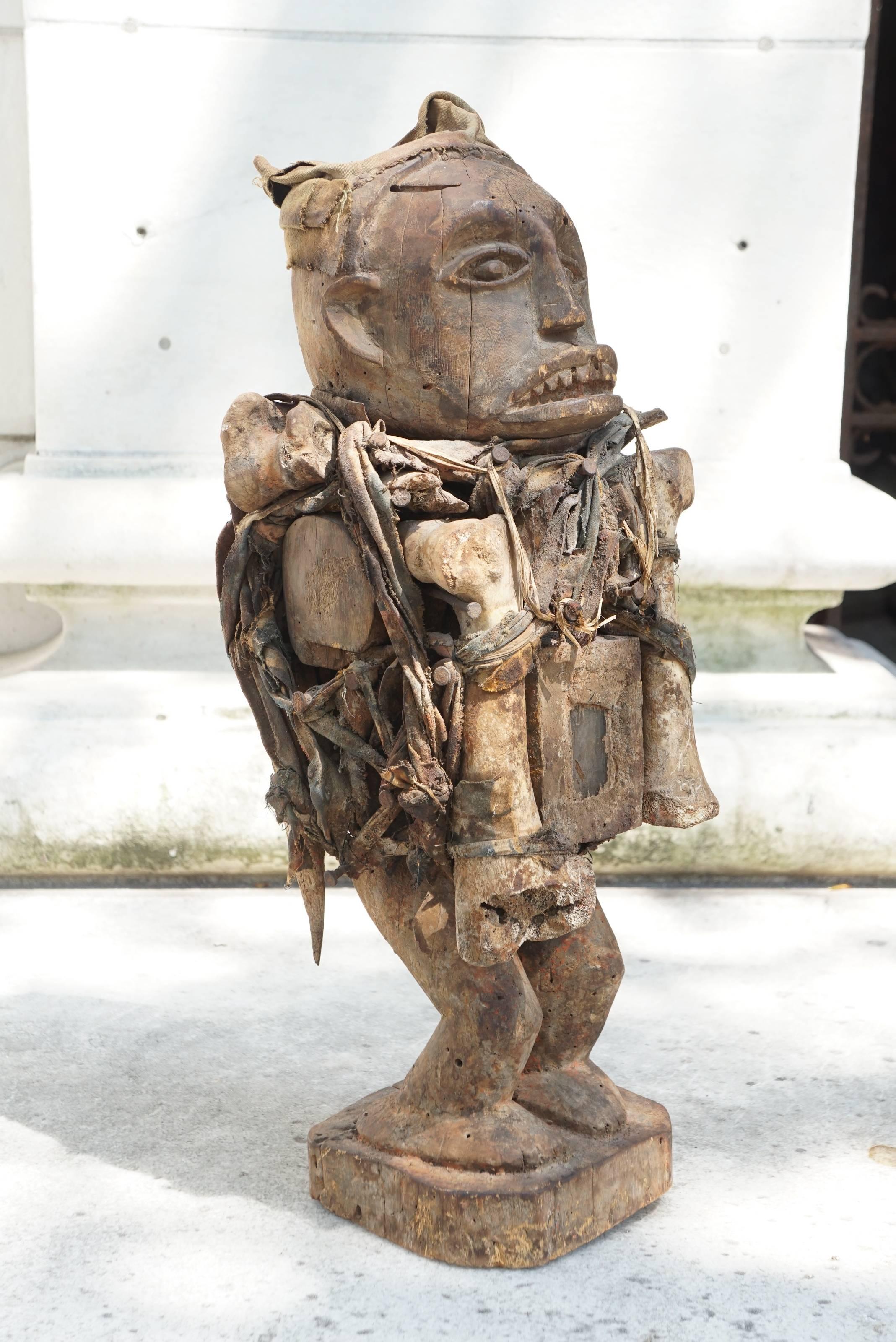 This large and finely carved comes from the Bakongo Peoples located within the Democratic Republic of the Congo. Made in the last days of the 19th century or early part of the 20th century boldly carved with a very dramatic face this figure and all