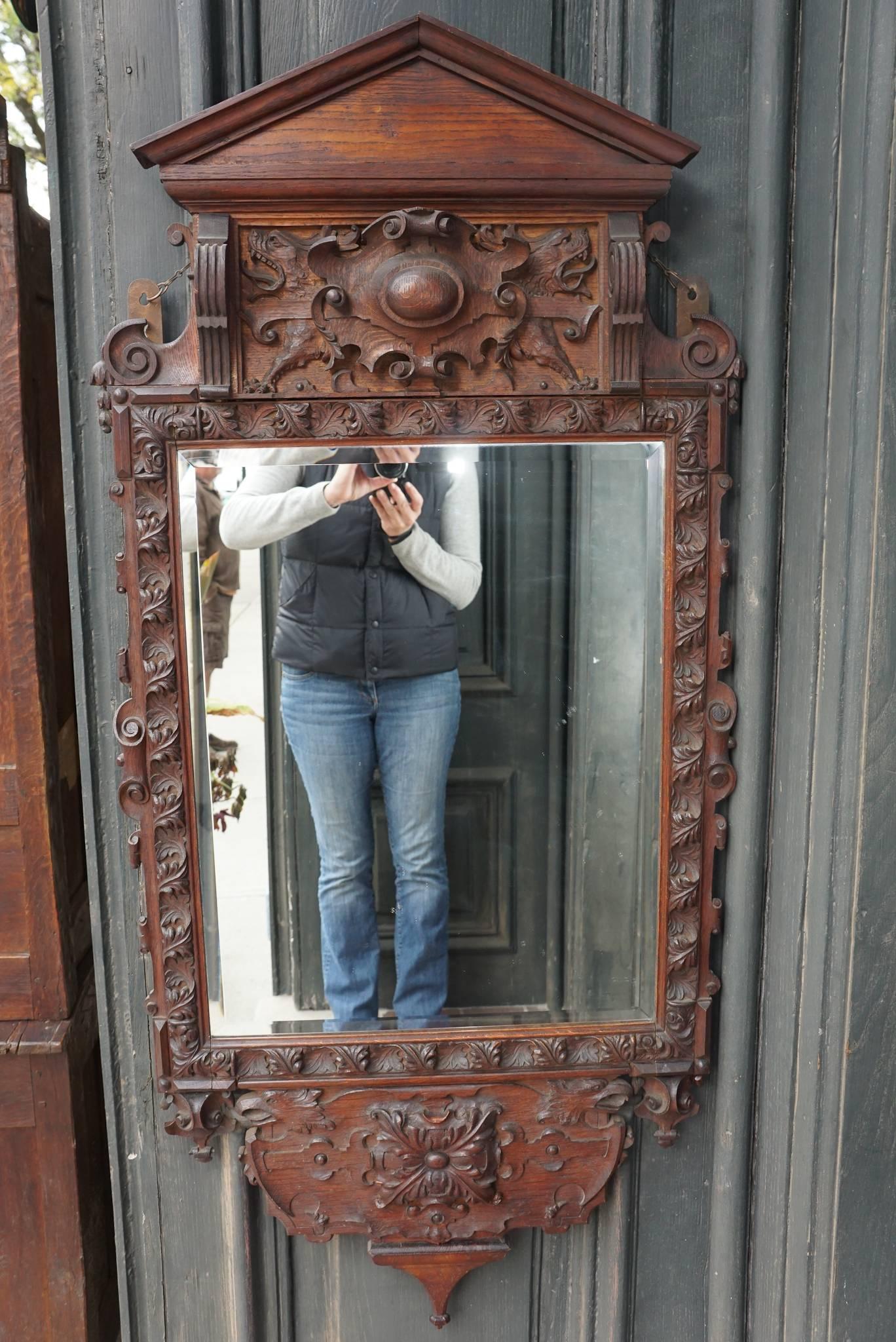 This incredibly stylish mirror done in the Georgian style was made in England, circa 1850. The Palladian styling favored by the likes of Chippendale and others is shown here in an Early Victorian frame. Carved in oak a wood hard to carve but capable