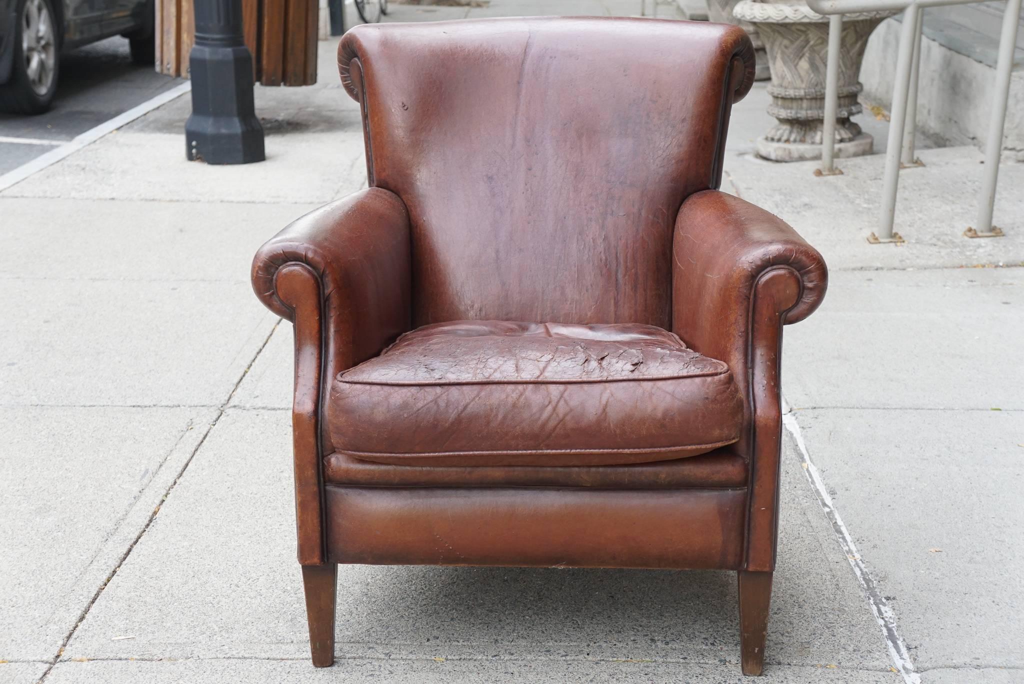 This fine period American Art Deco club chair is comfortable and mannish in form and style. Created circa 1930-1935 in walnut and upholstered in leather the chair has acquired a rich patina of age thru use. The chairs color and patina are great