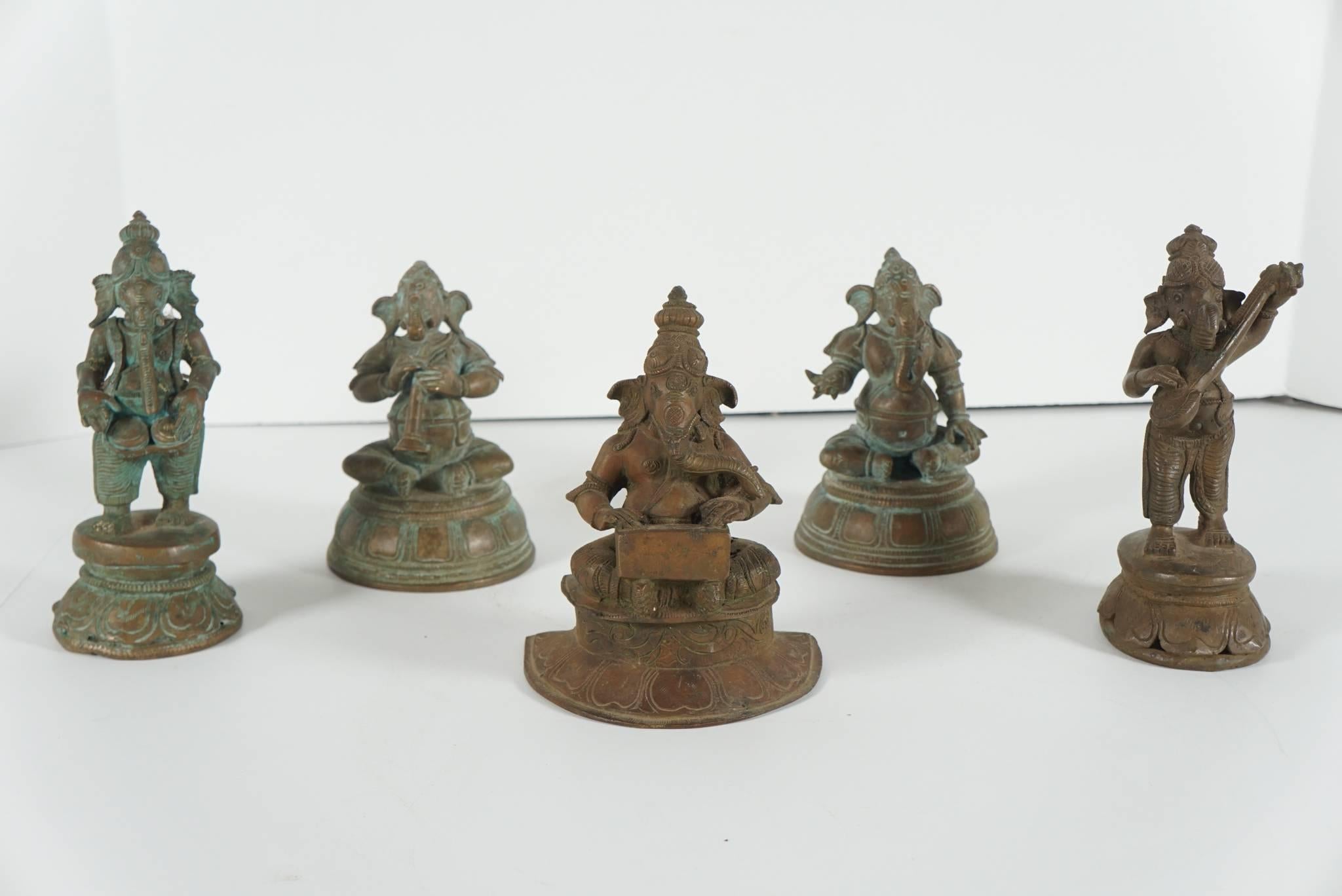 The figures form a band. Each figure is individually cast with many details and rest upon differently shaped lotus bases. While most likely made as a group the separate figures have slightly different patinas and wear to that color creating a