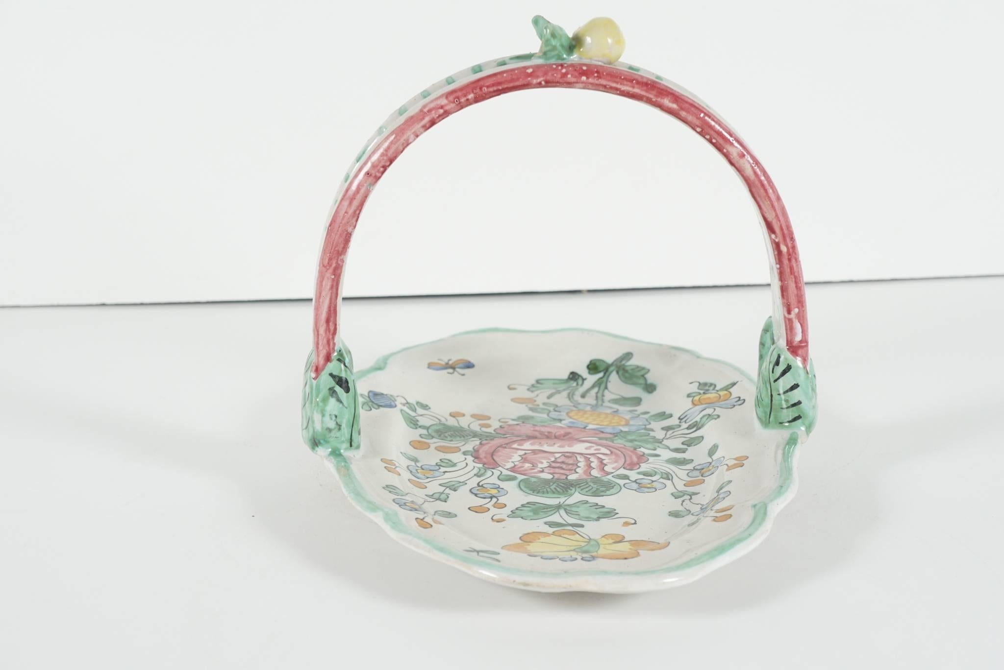 This earthen ware handmade tray comes from Italy and was made as a lighthearted answer to refined city porcelains used in upscale houses. Humble but hand made the decoration is charming and refined. Painted in light colors showing flowers and leaves
